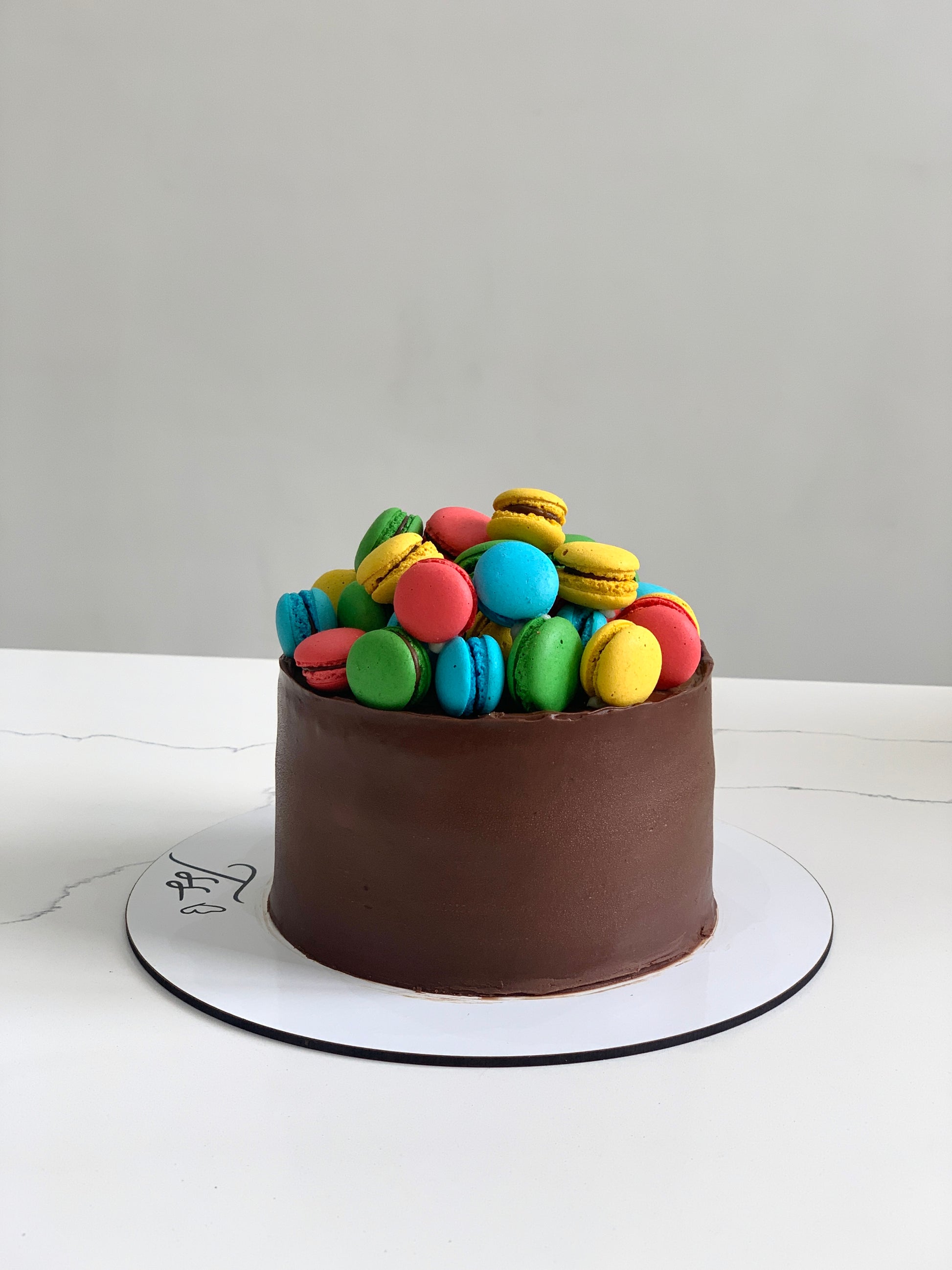 Classic Cakes by The Sinful Spoon displayed on a plate, showcasing their rich textures and colorful frosting details.
