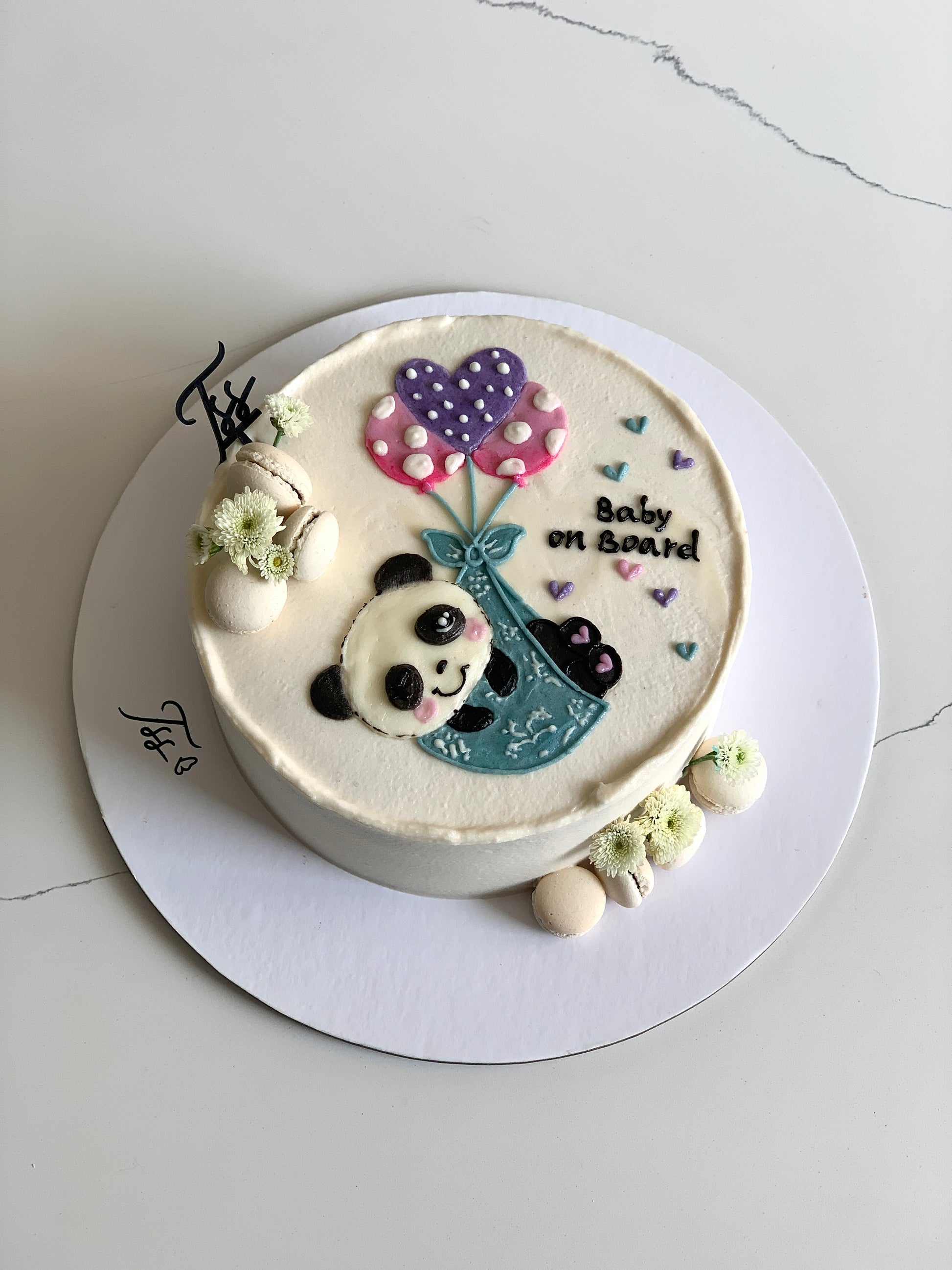 Decorative buttercream illustration cake by The Sinful Spoon with colorful floral and abstract designs on smooth frosting.
