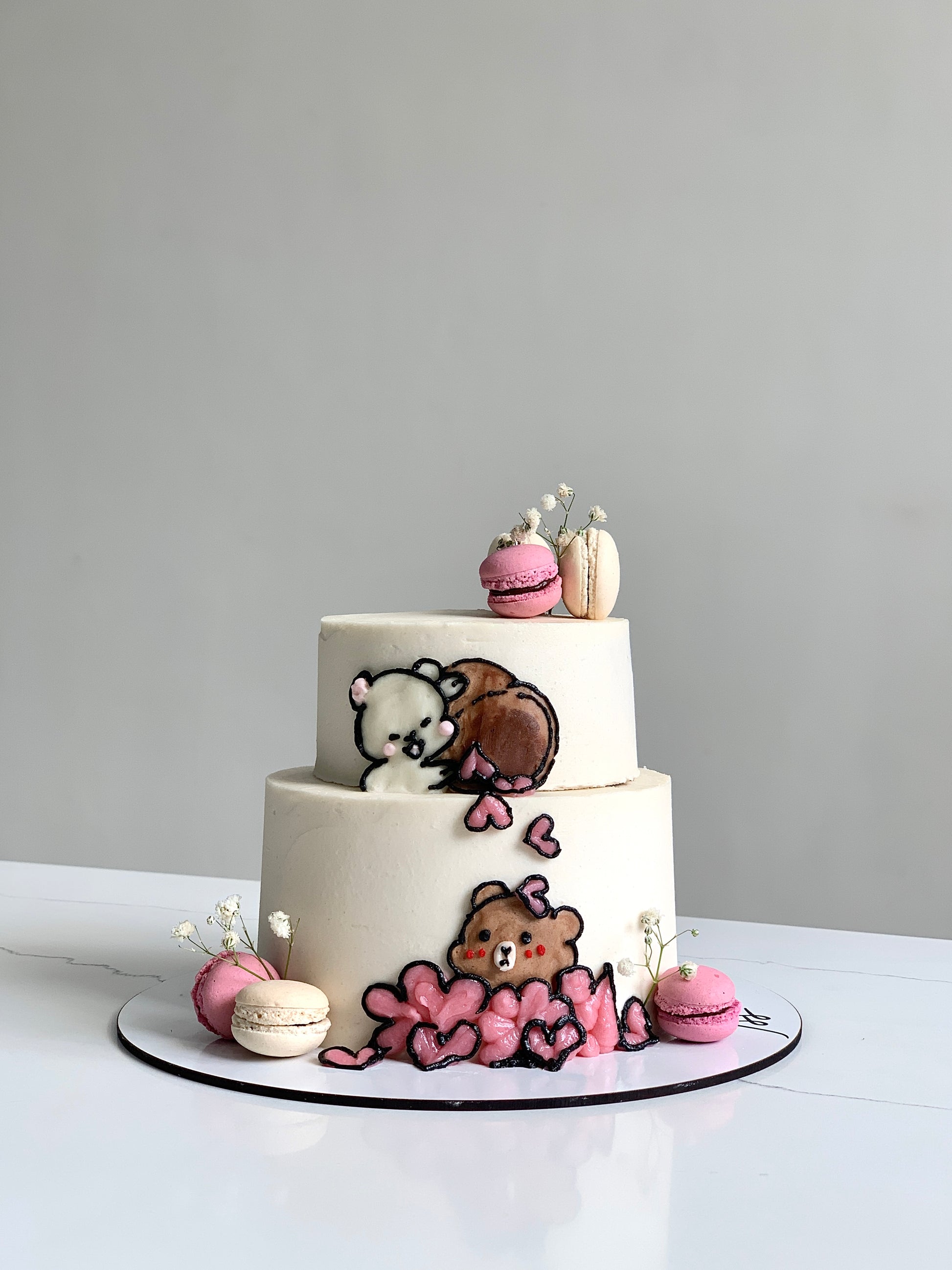 Miniature tier cakes from The Sinful Spoon, featuring colorful frosting and decorative toppings on multiple small cake layers.