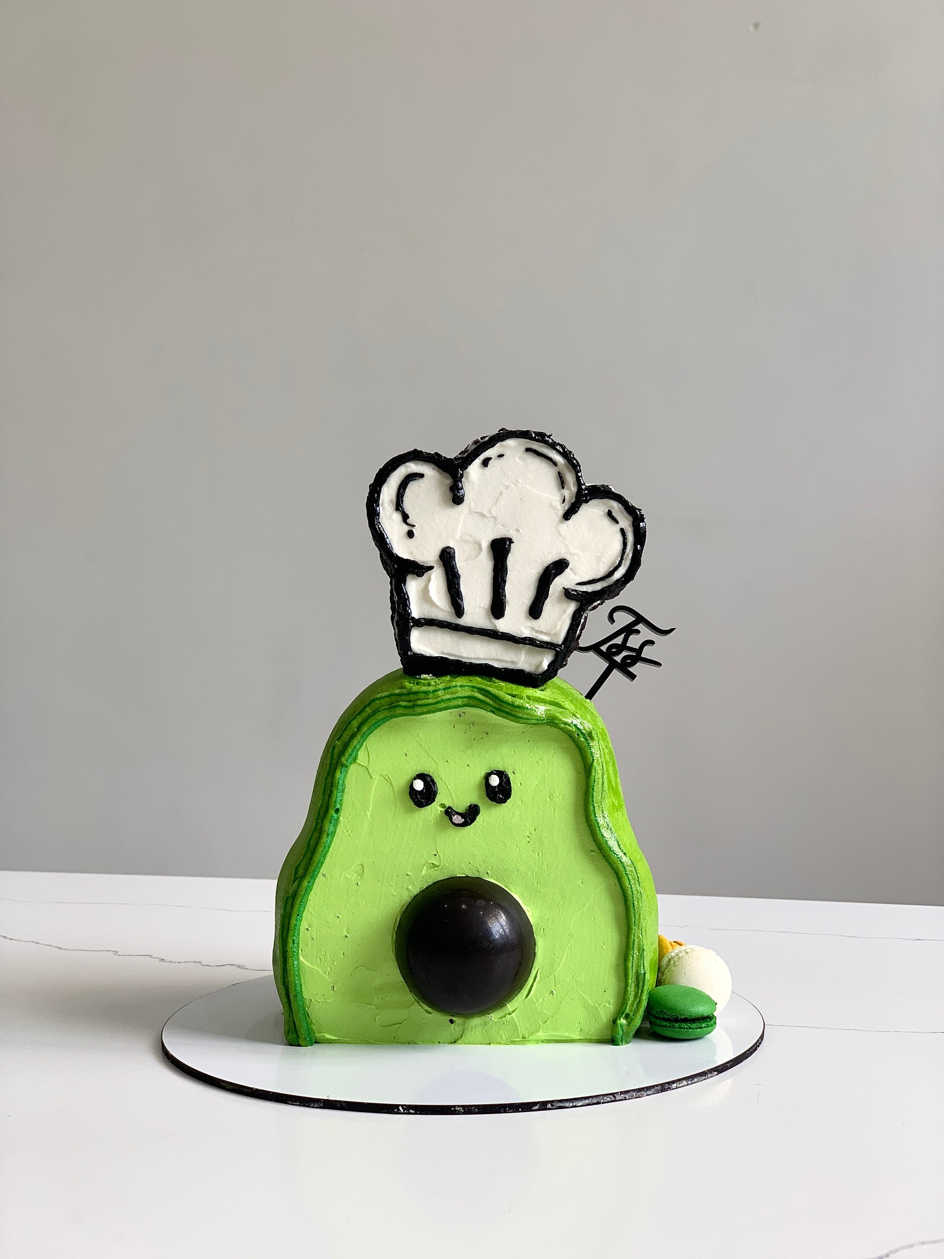 Decorative shape cakes by The Sinful Spoon featuring colorful icing and intricate designs on a white background.