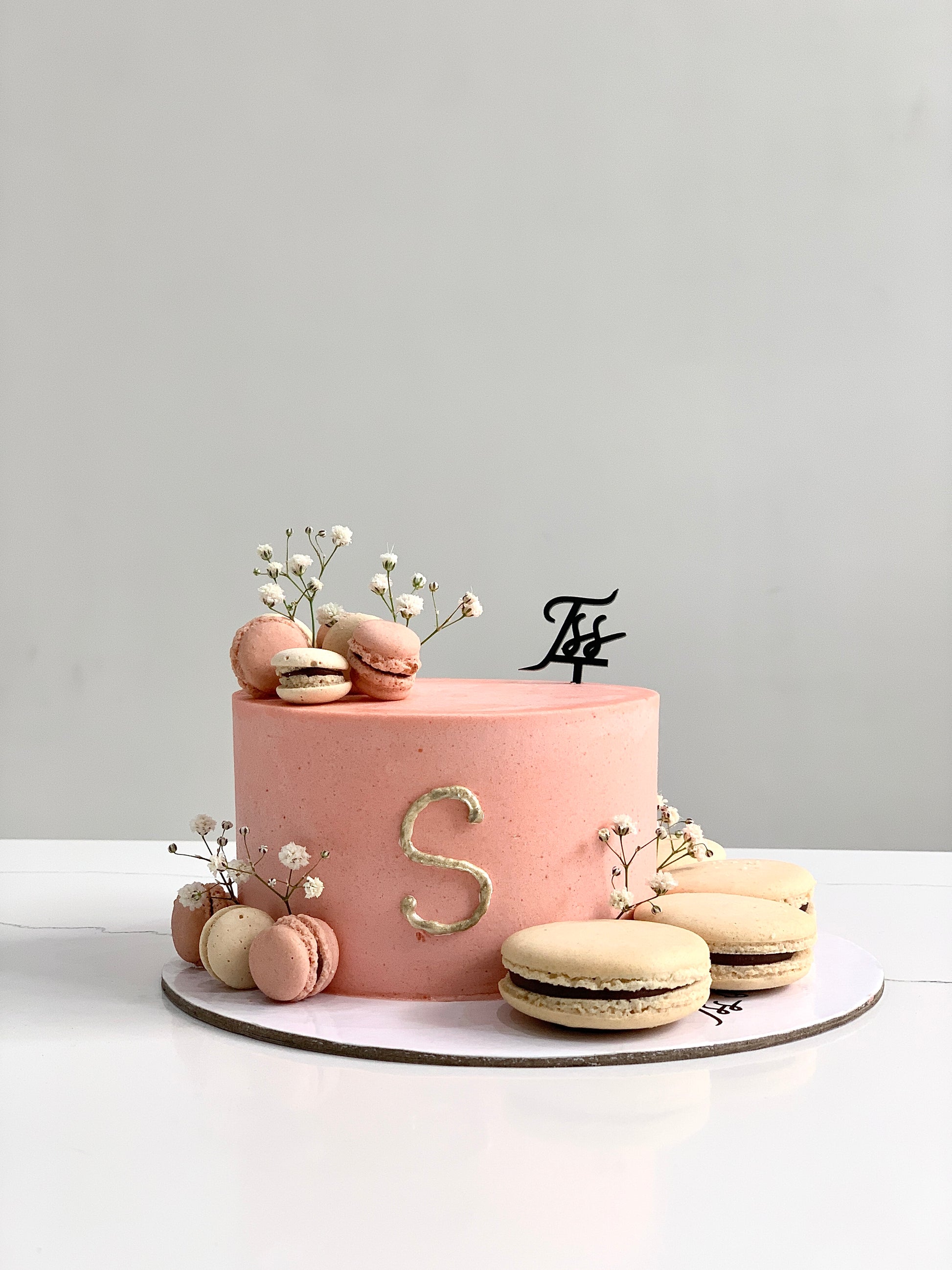 Slice of classic sponge cake from The Sinful Spoon with creamy frosting and colorful sprinkles on top.