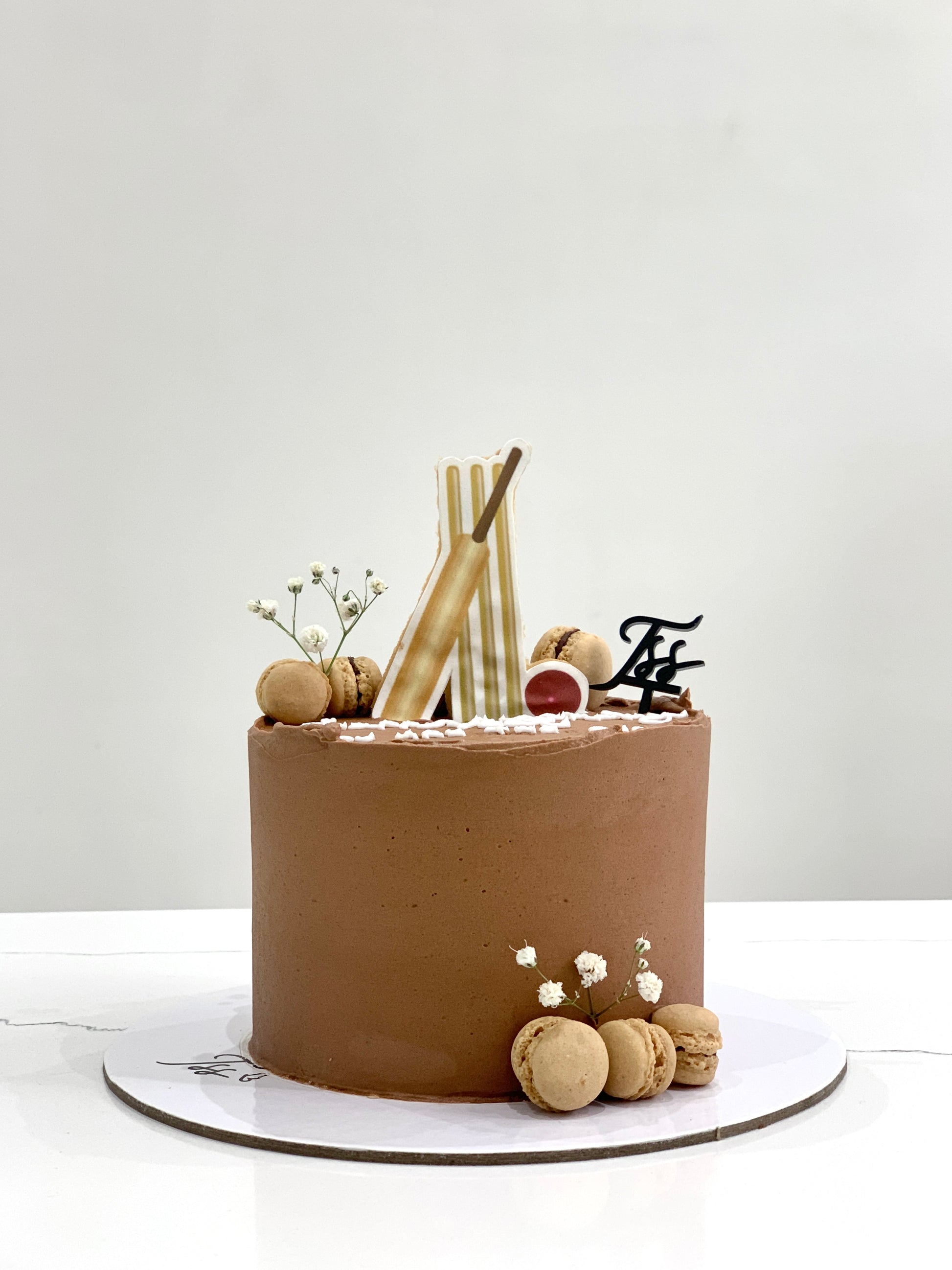 Edible paper cake decorated for a baby boy celebration with blue accents, from The Sinful Spoon.