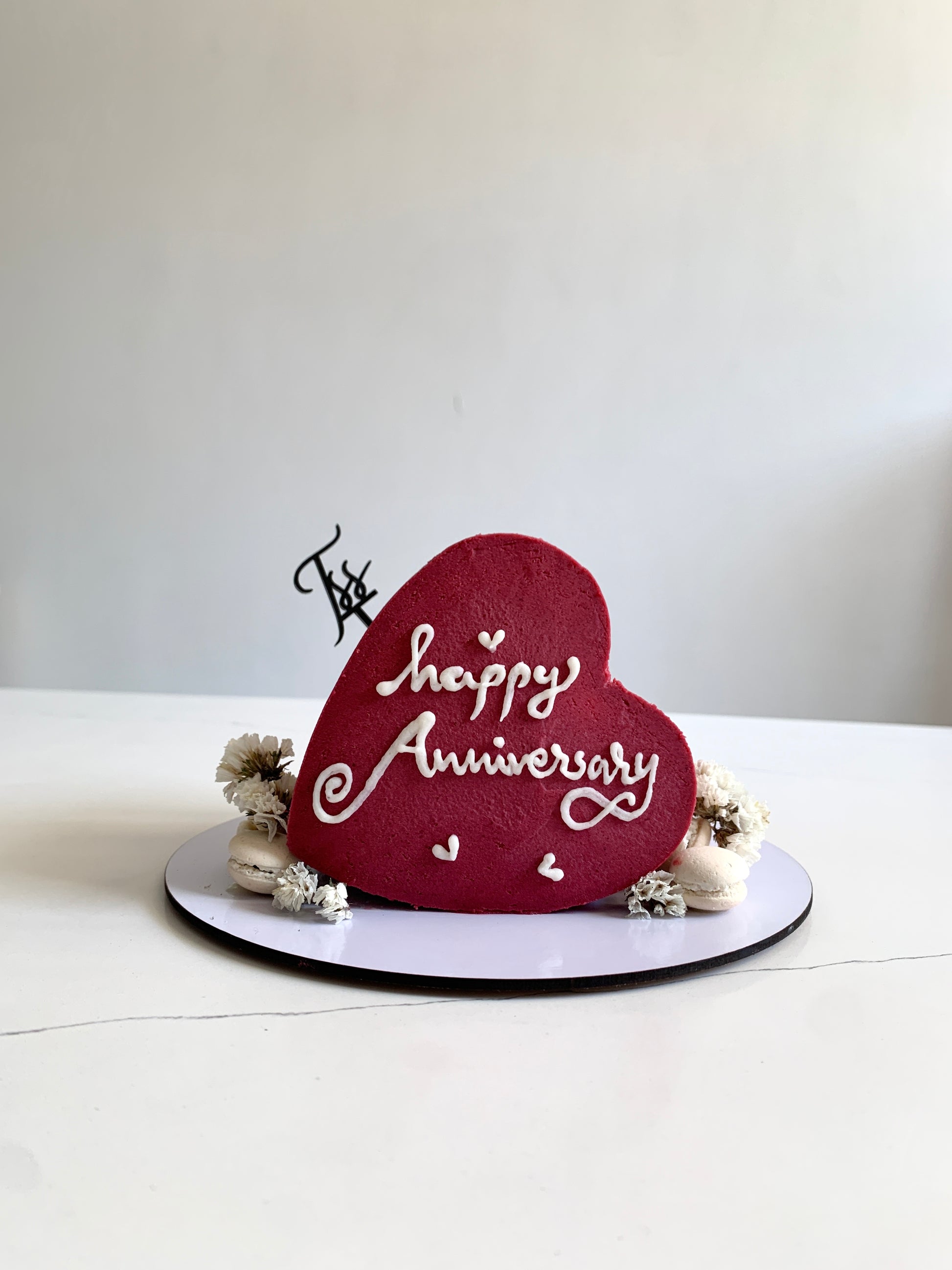 Heart-shaped cakes from The Sinful Spoon, decorated with pink and white icing, perfect for romantic celebrations.