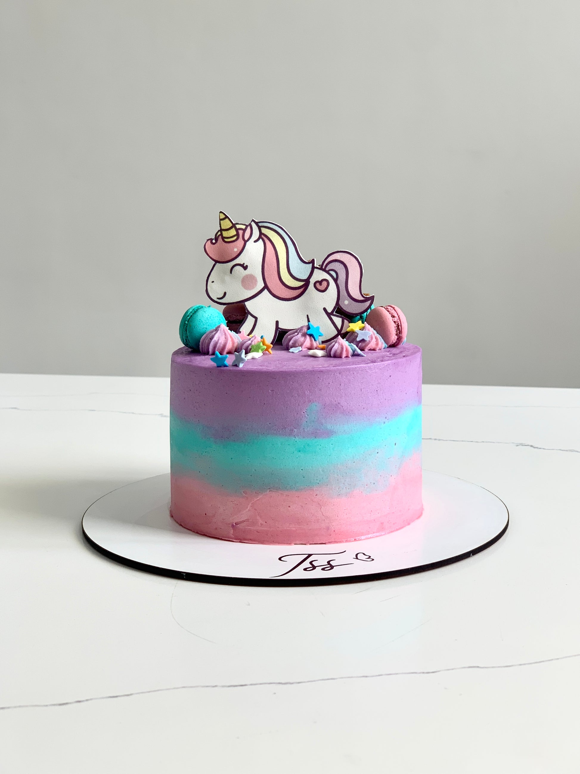 Colorful edible paper cake topper featuring a baby girl design for cake decoration by The Sinful Spoon.