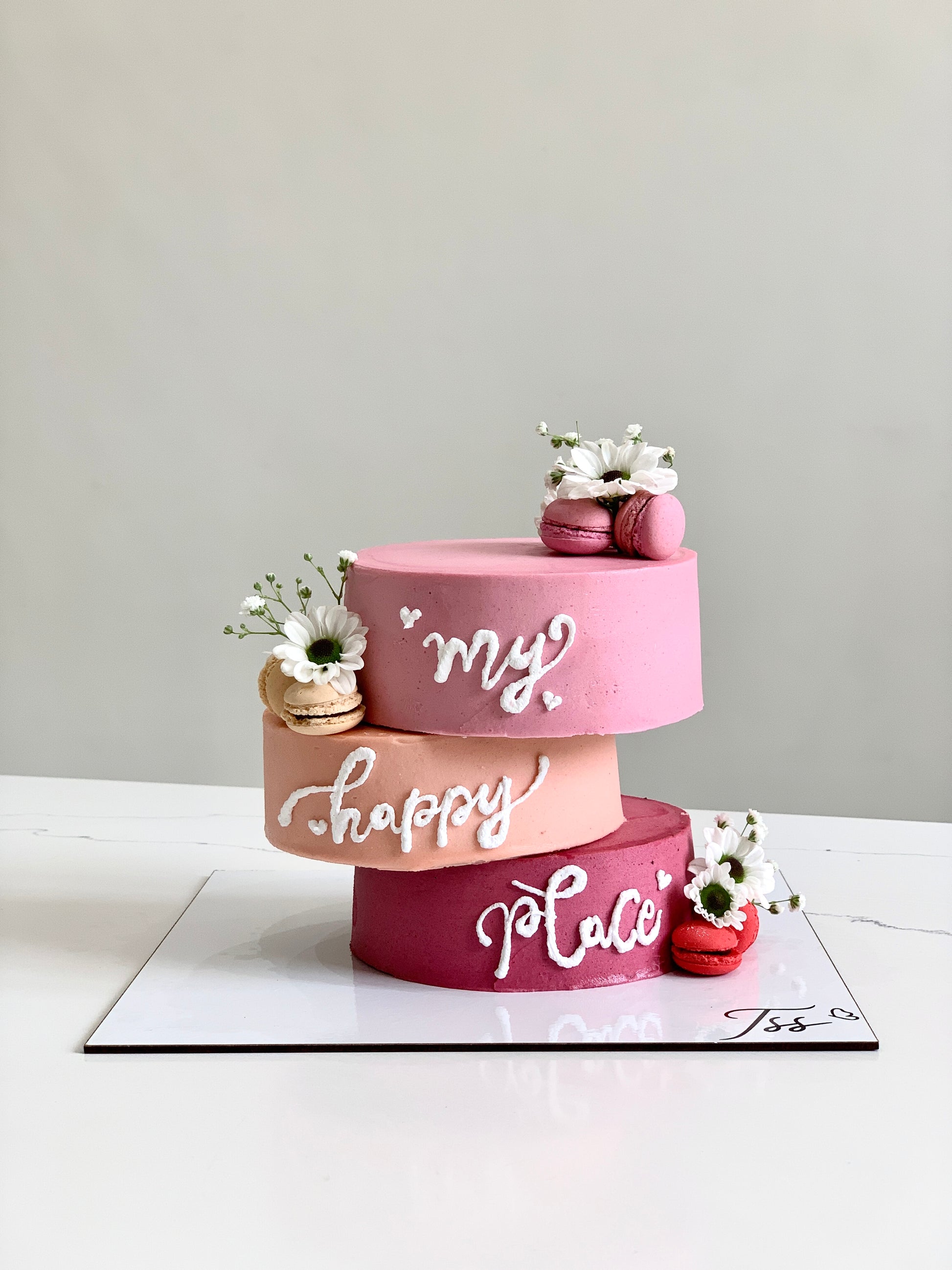 Asymmetrical cakes from The Sinful Spoon showcasing creative, layered desserts with varied shapes and vibrant frosting details.