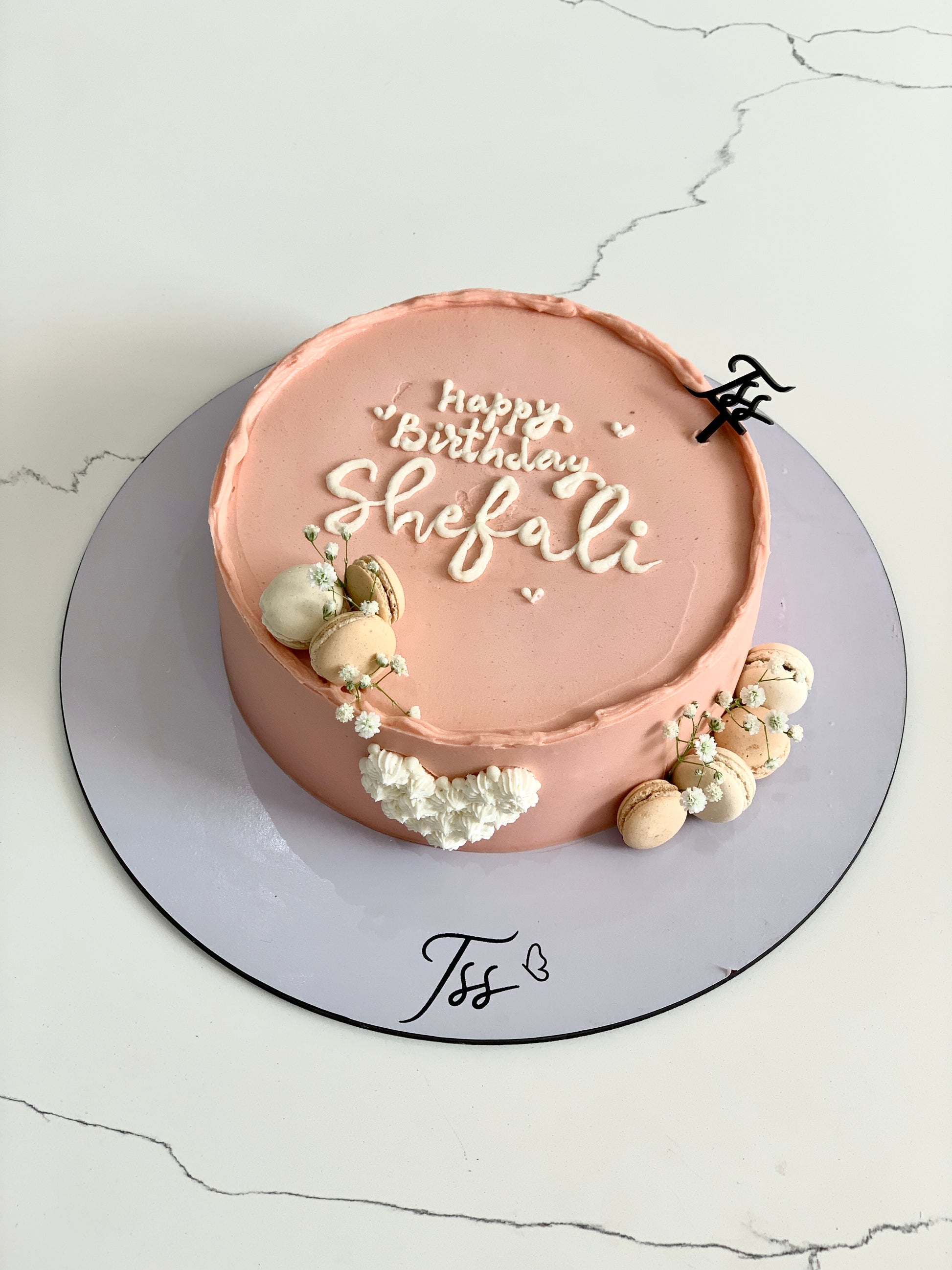 Decorative Mother's Day cake from The Sinful Spoon with floral design and pastel frosting, perfect for celebrating moms.