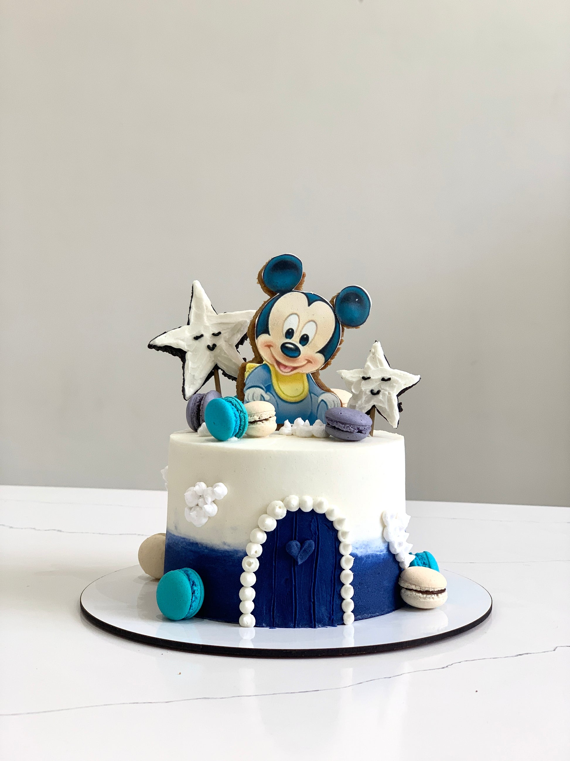 Edible paper cake decorated for a baby boy celebration by The Sinful Spoon, featuring colorful baby-themed designs.