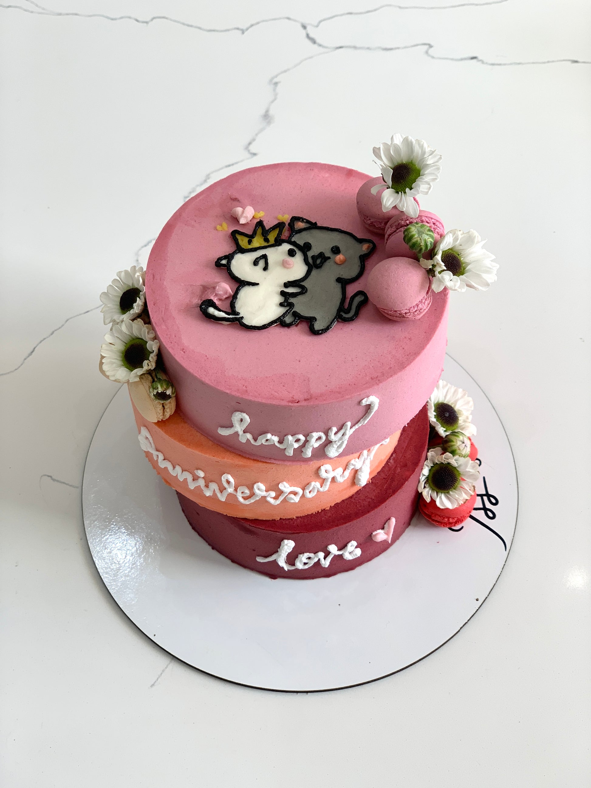 Asymmetrical cake by The Sinful Spoon featuring layered frosting and creative design on a white plate.