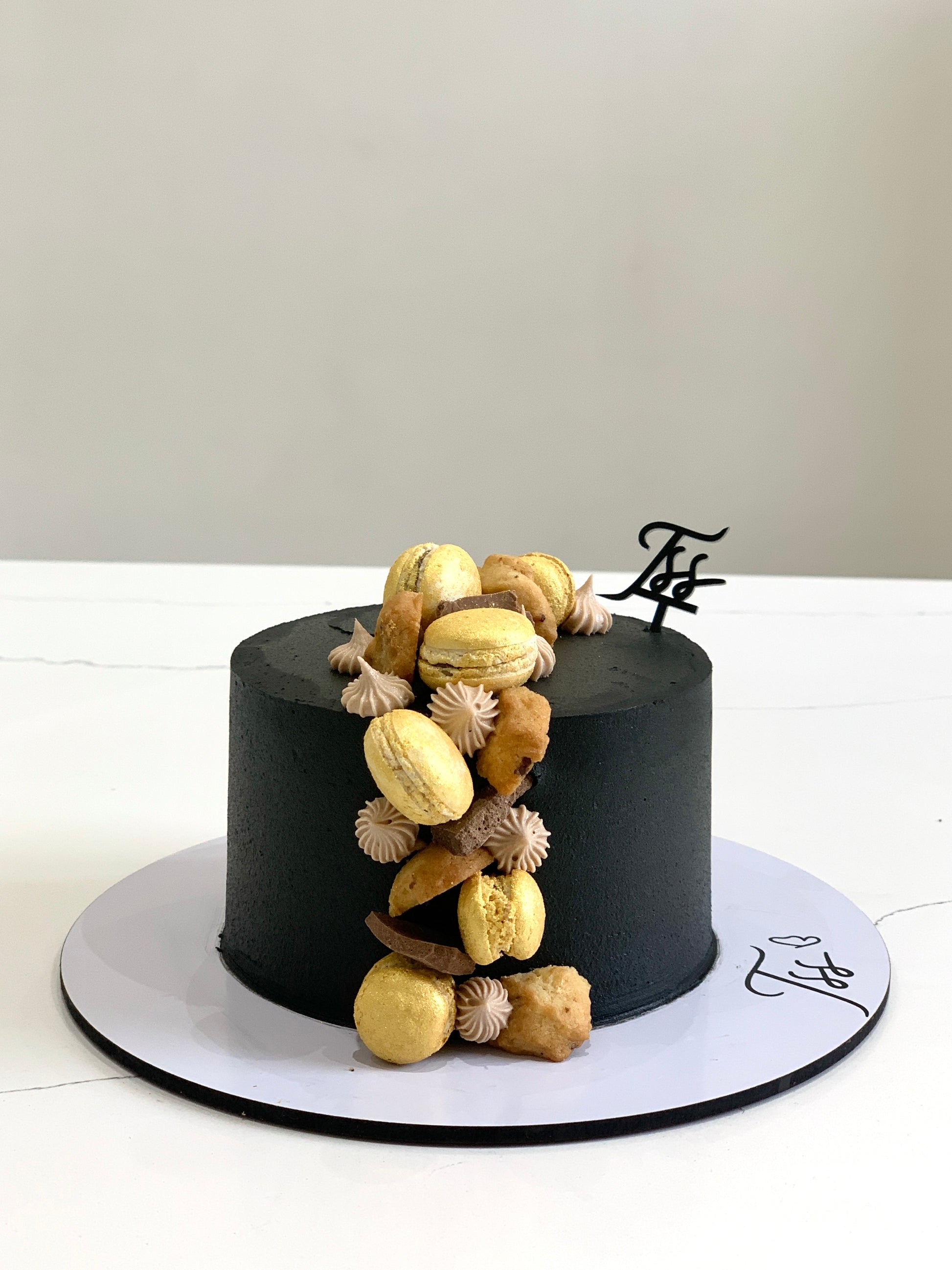 Decorative Father’s Day cake from The Sinful Spoon with colorful frosting and themed cake topper on a white background.