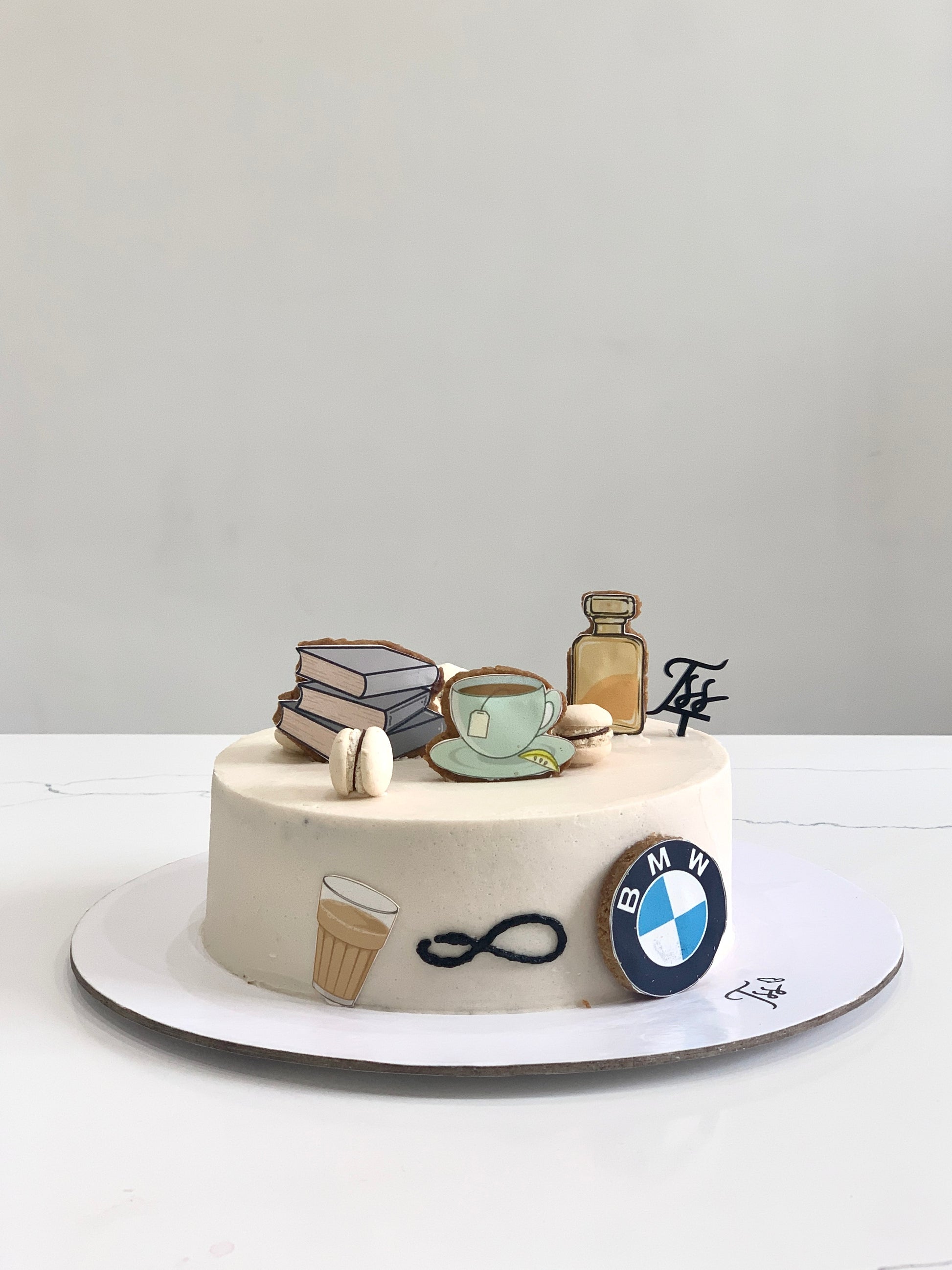 Edible paper cake decorated with colorful icing and floral designs, crafted by The Sinful Spoon.