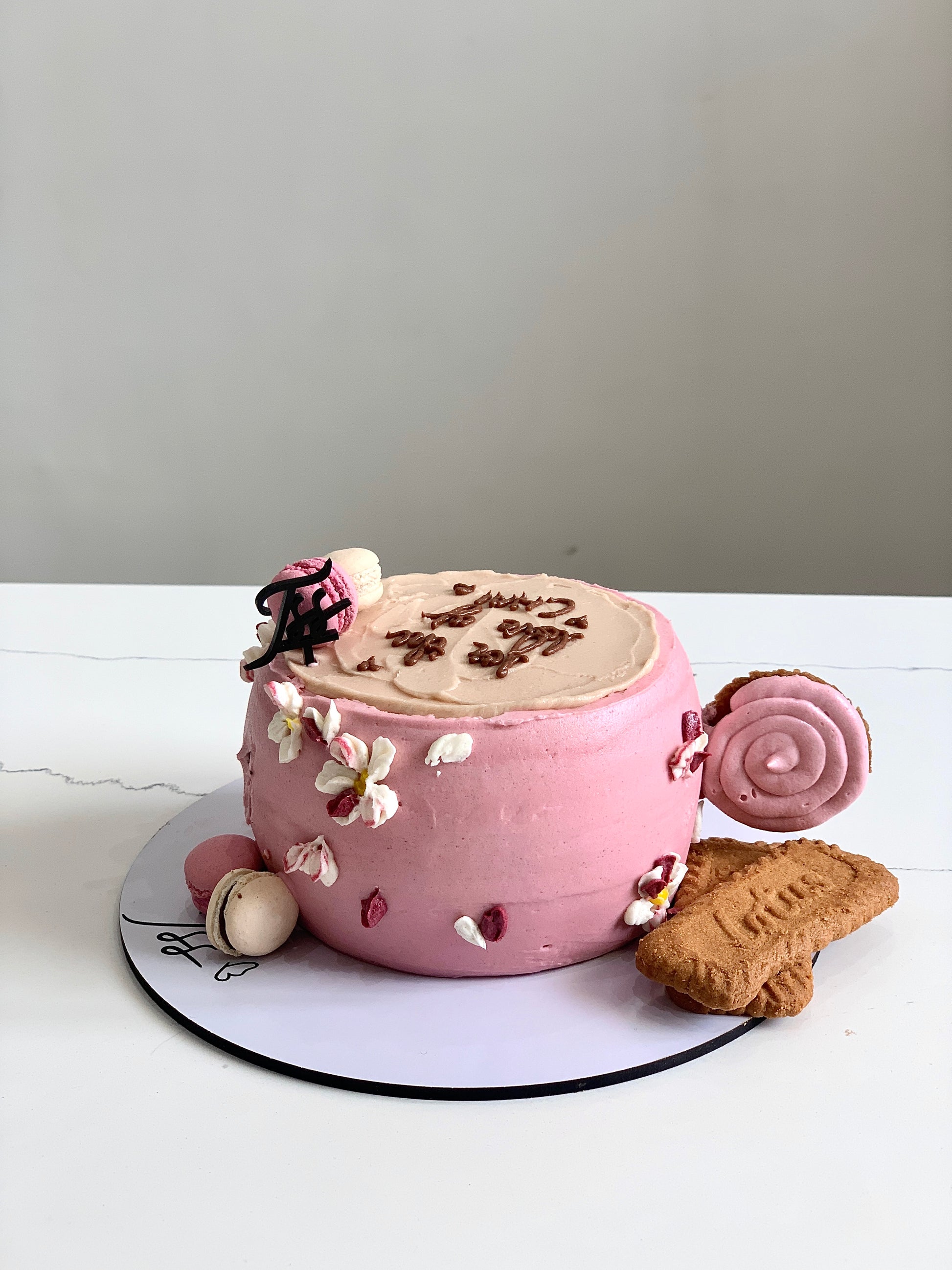 Shape cakes cup from The Sinful Spoon featuring a colorful, detailed mug-shaped cake with intricate decorations.