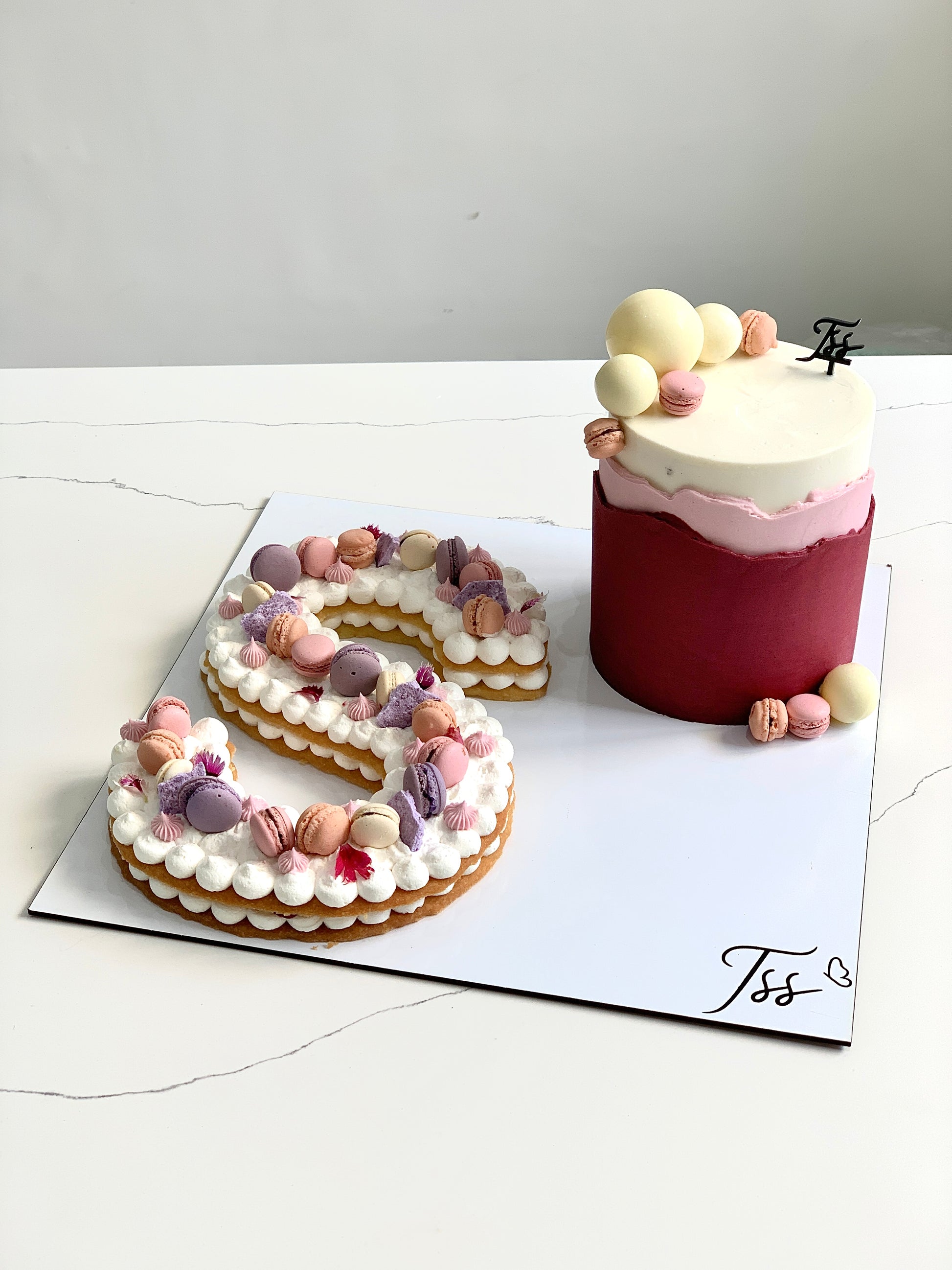 Assorted combo cakes from The Sinful Spoon with colorful frosting and decorative toppings on a white plate.