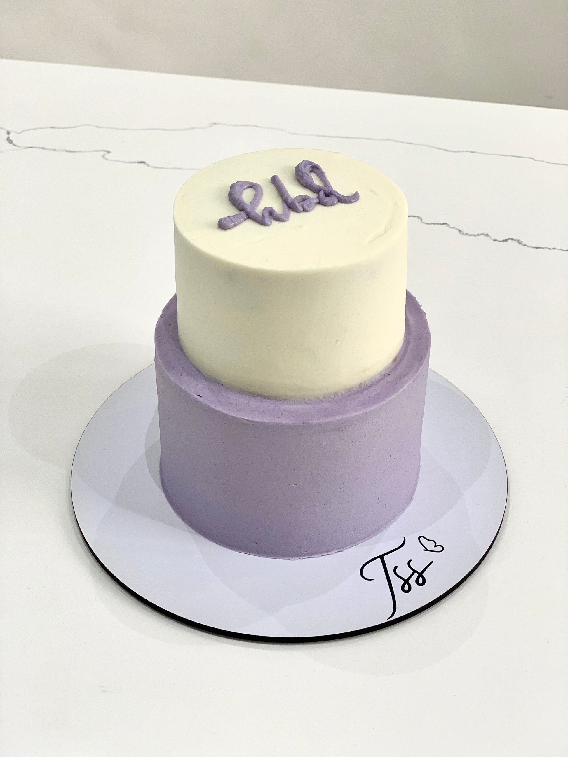 Miniature tier cakes from The Sinful Spoon with pastel frosting and decorative toppings, perfect for small celebrations.