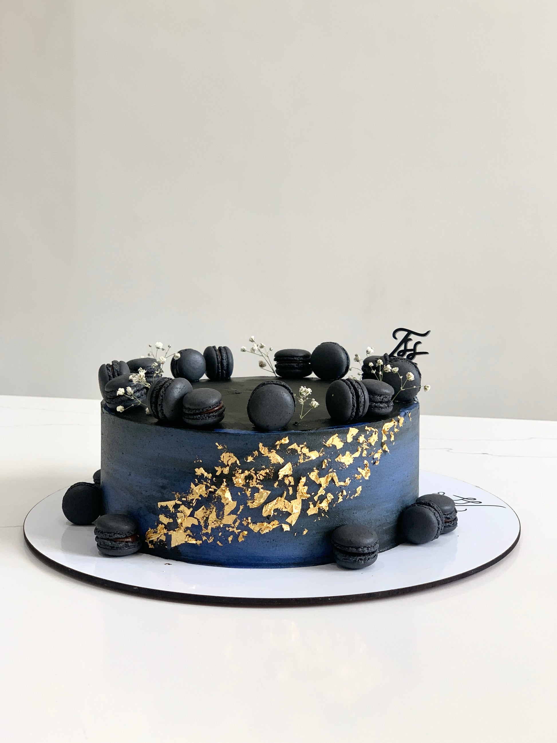 Decorative Father's Day cake from The Sinful Spoon topped with themed frosting and festive decorations.