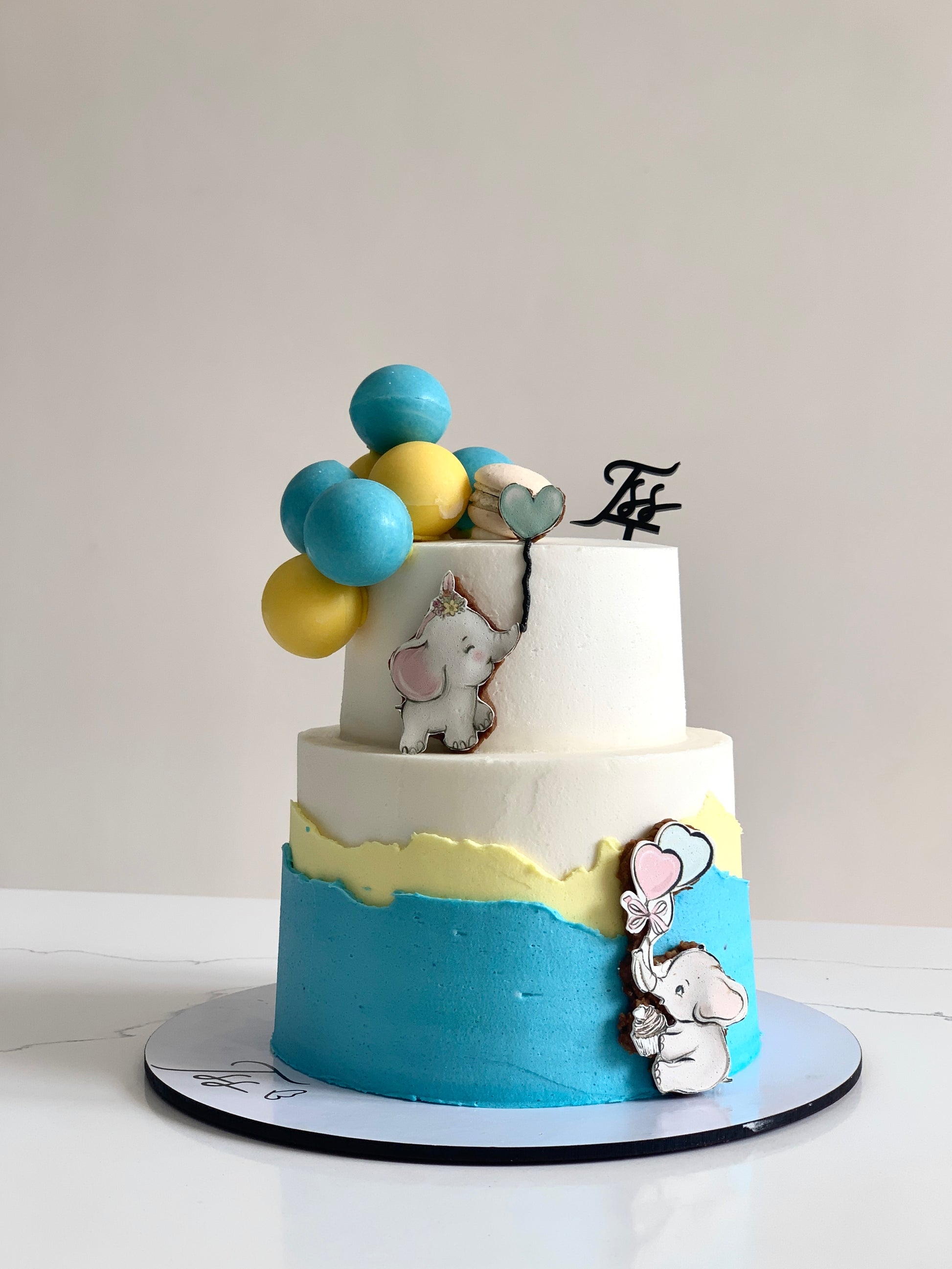 Miniature tiered cakes from The Sinful Spoon, showcasing small, elegant cake layers with decorative frosting and toppings.