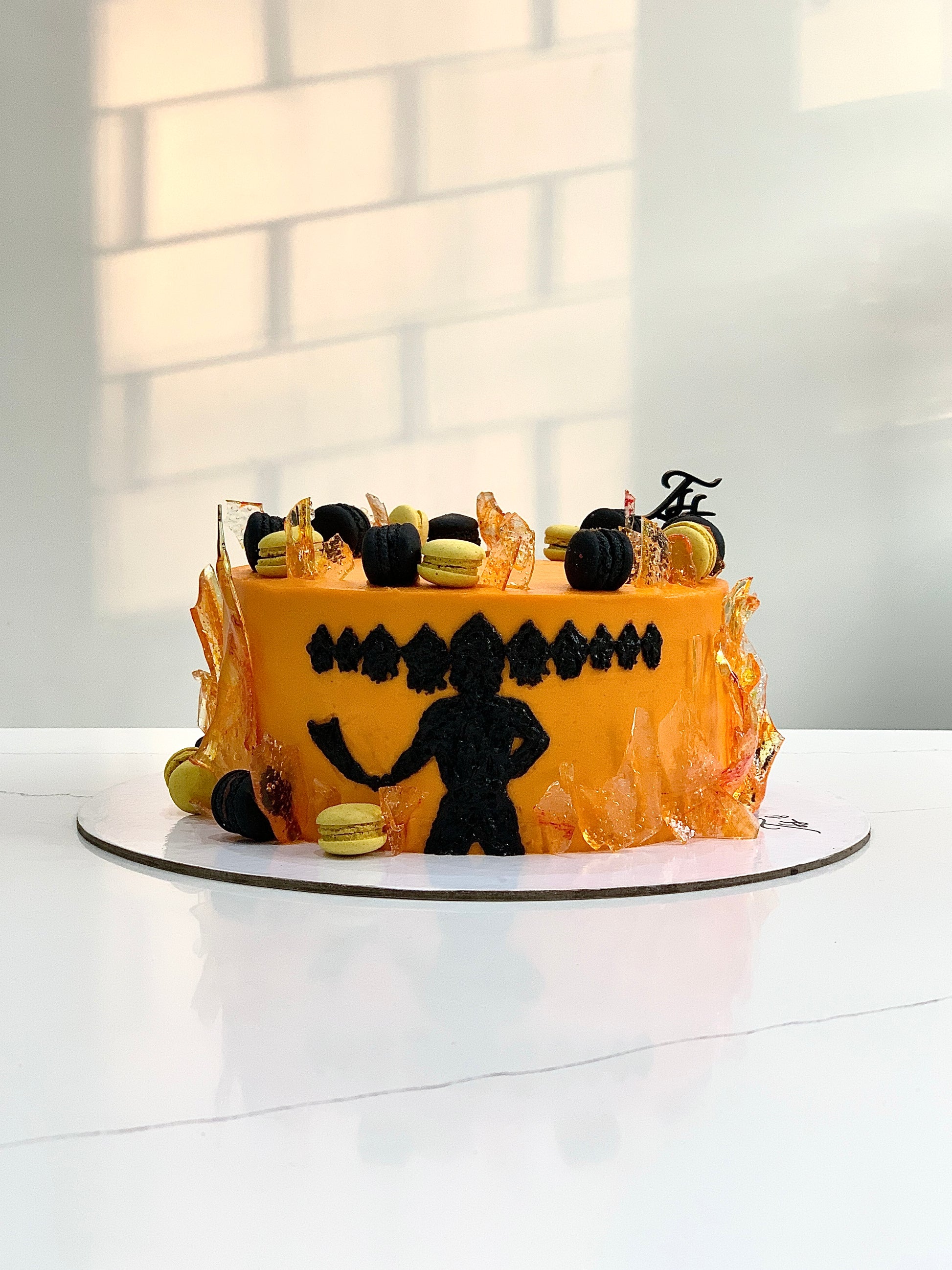 Decorative festive cake from The Sinful Spoon with colorful icing and holiday-themed toppings, perfect for celebrations.