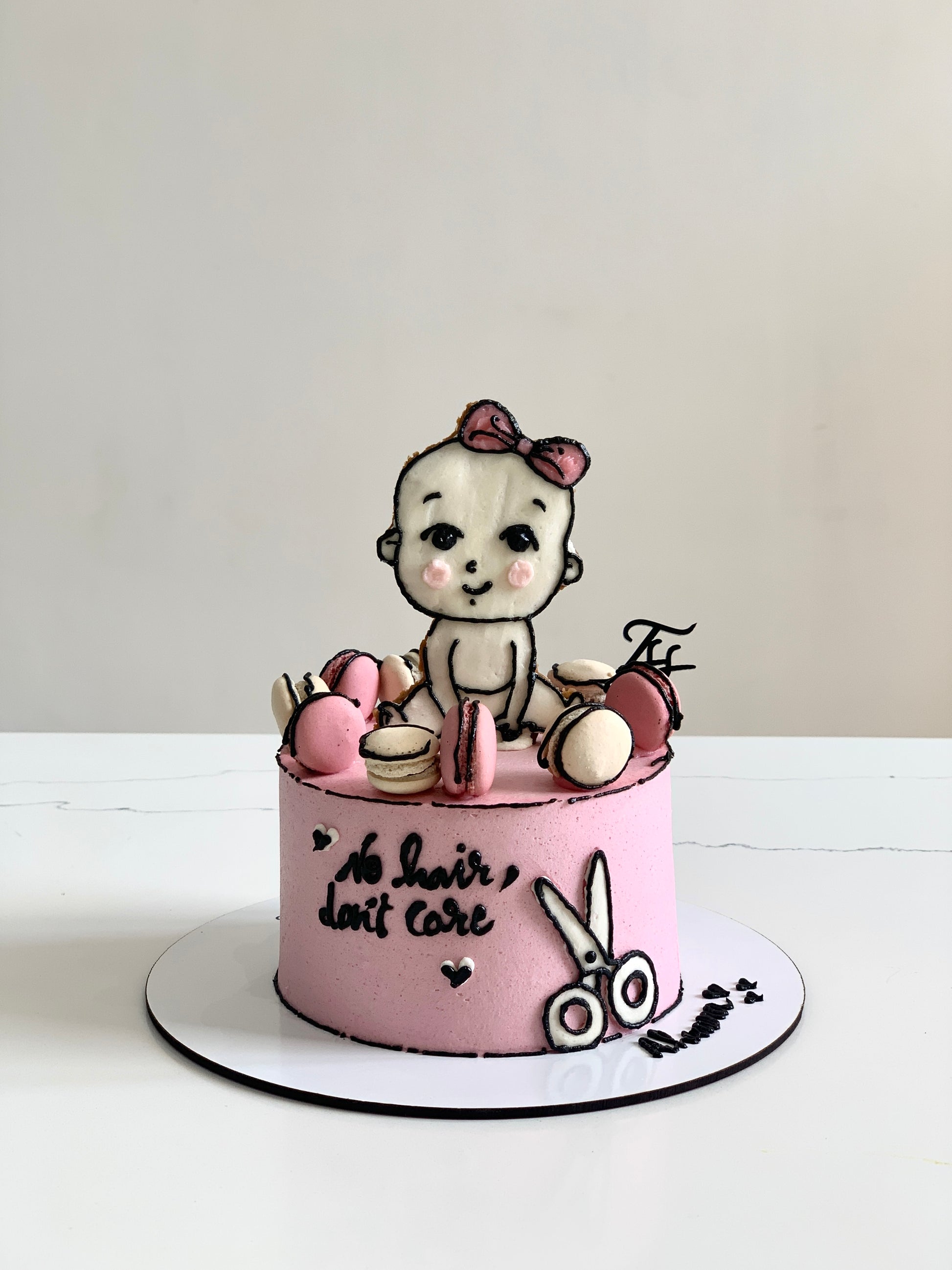 Edible paper cake decorated for a baby girl celebration by The Sinful Spoon, featuring colorful baby-themed designs.