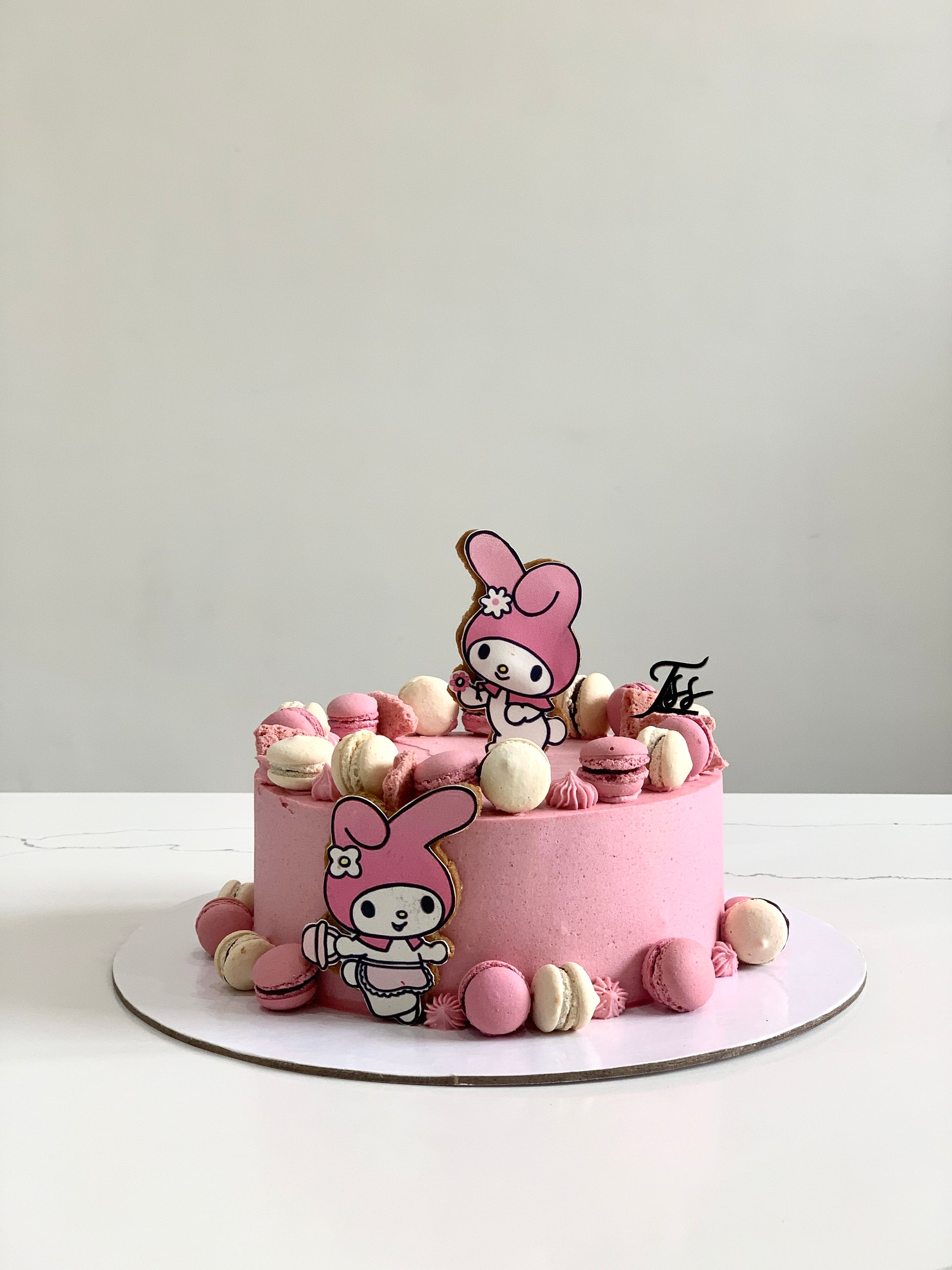 Edible paper cake featuring a baby girl design by The Sinful Spoon, decorated with colorful floral and baby-themed elements.