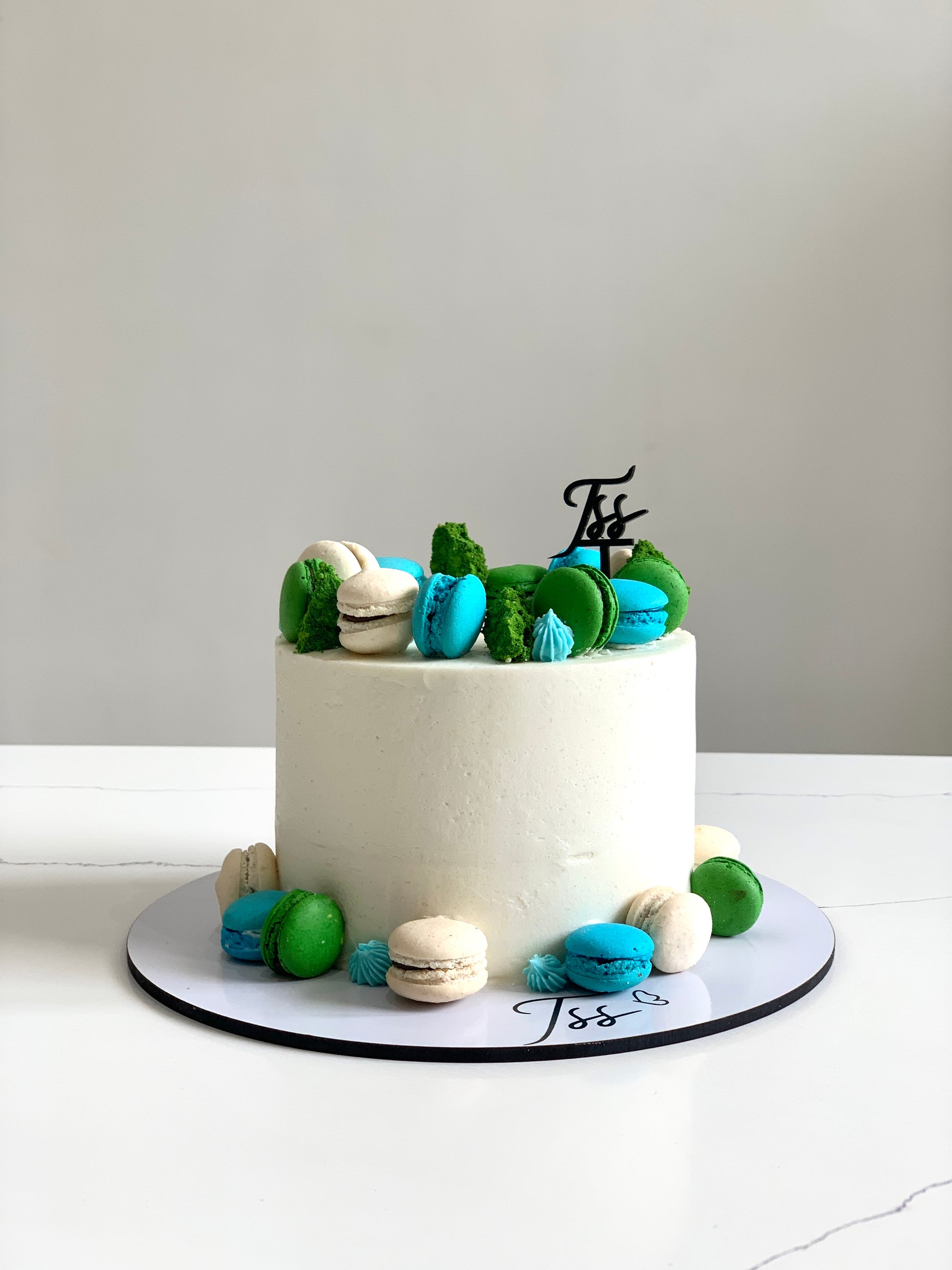 A selection of classic cakes from The Sinful Spoon, featuring layered desserts with colorful frosting and decorative toppings.