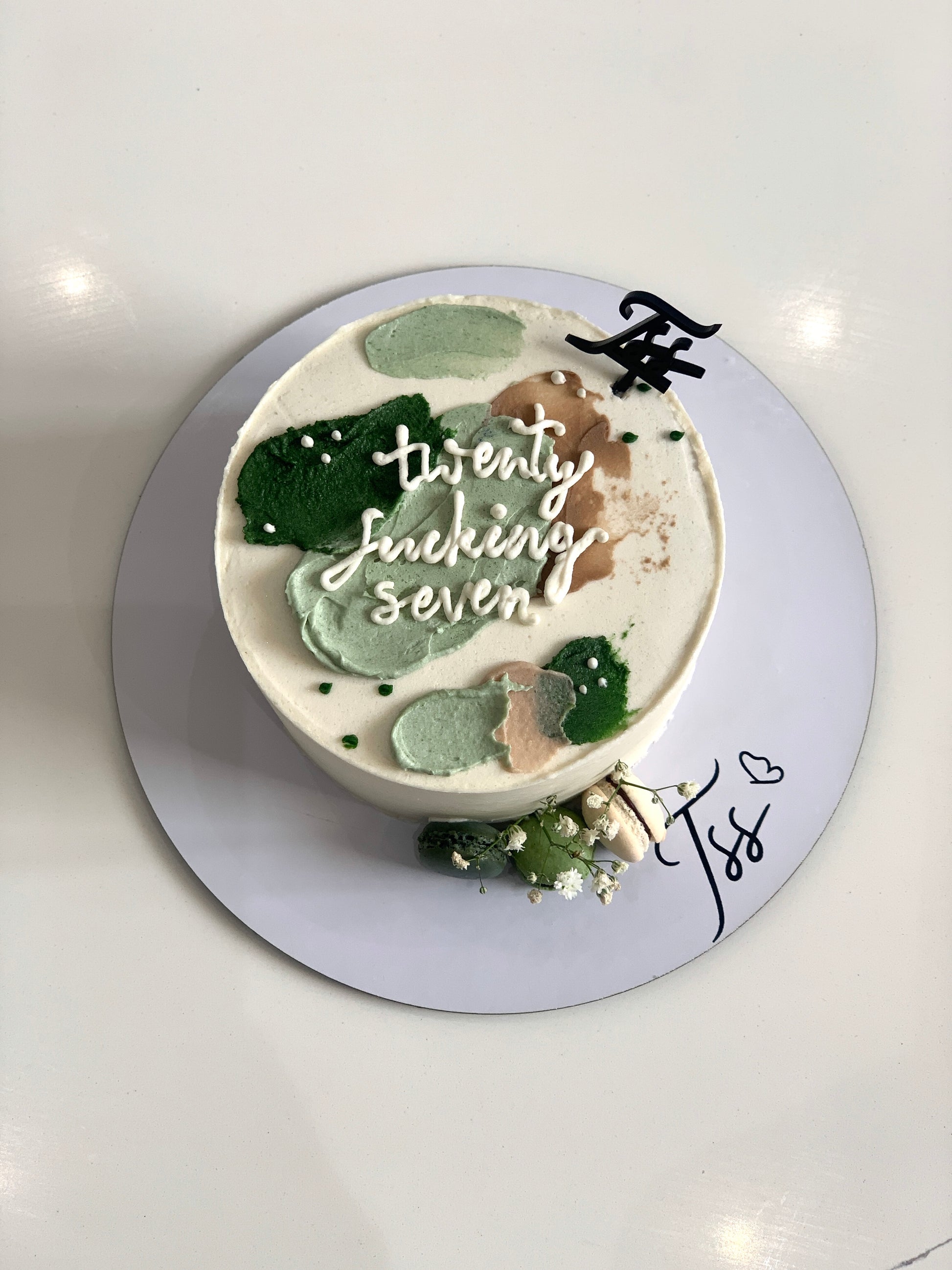 Colorful bento cakes from The Sinful Spoon, featuring vibrant frosting and decorative toppings on small, individual cake portions.