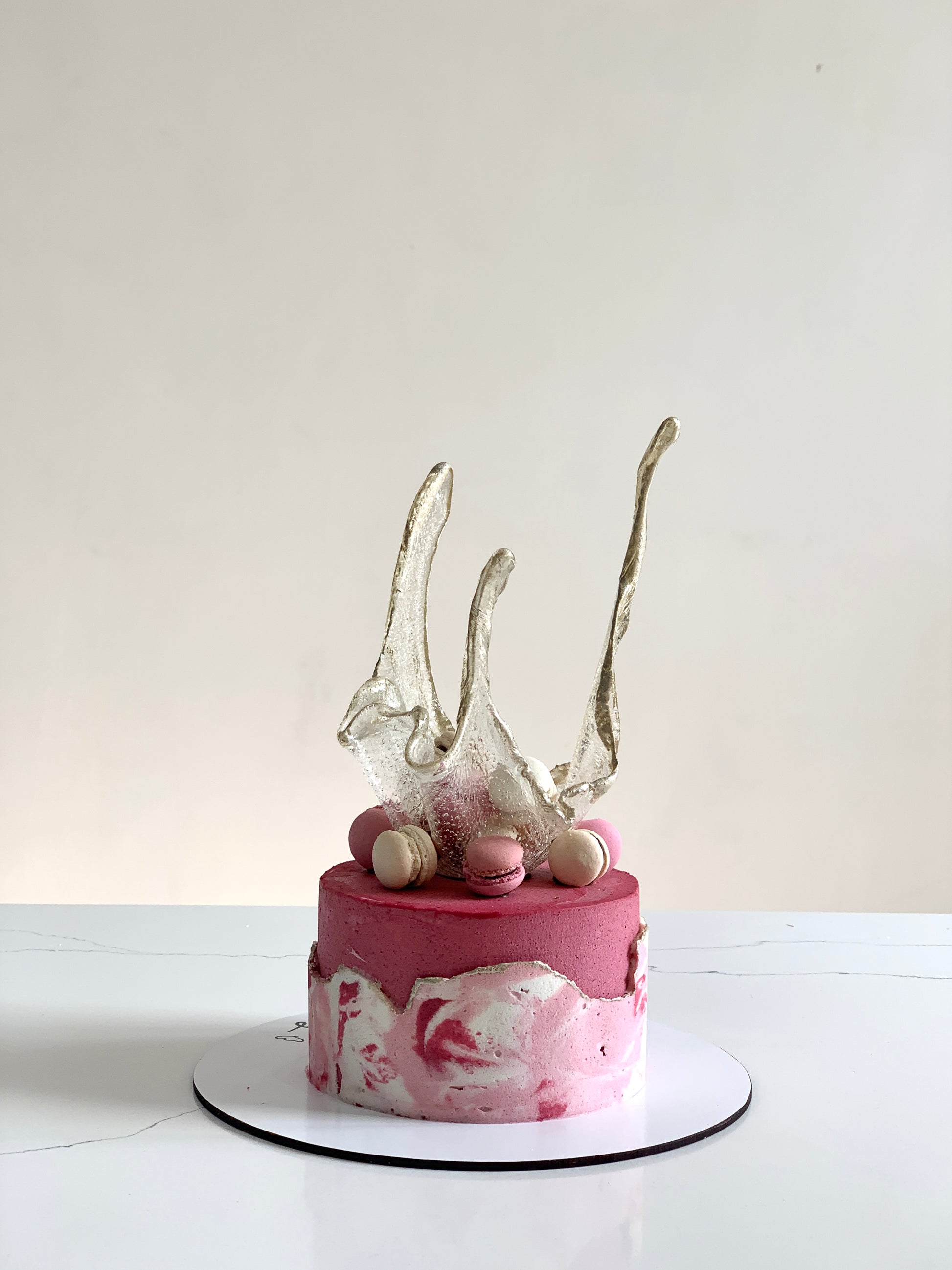 Isomalt cakes from The Sinful Spoon, colorful sugar art pieces for confectionery decoration, on a white background.