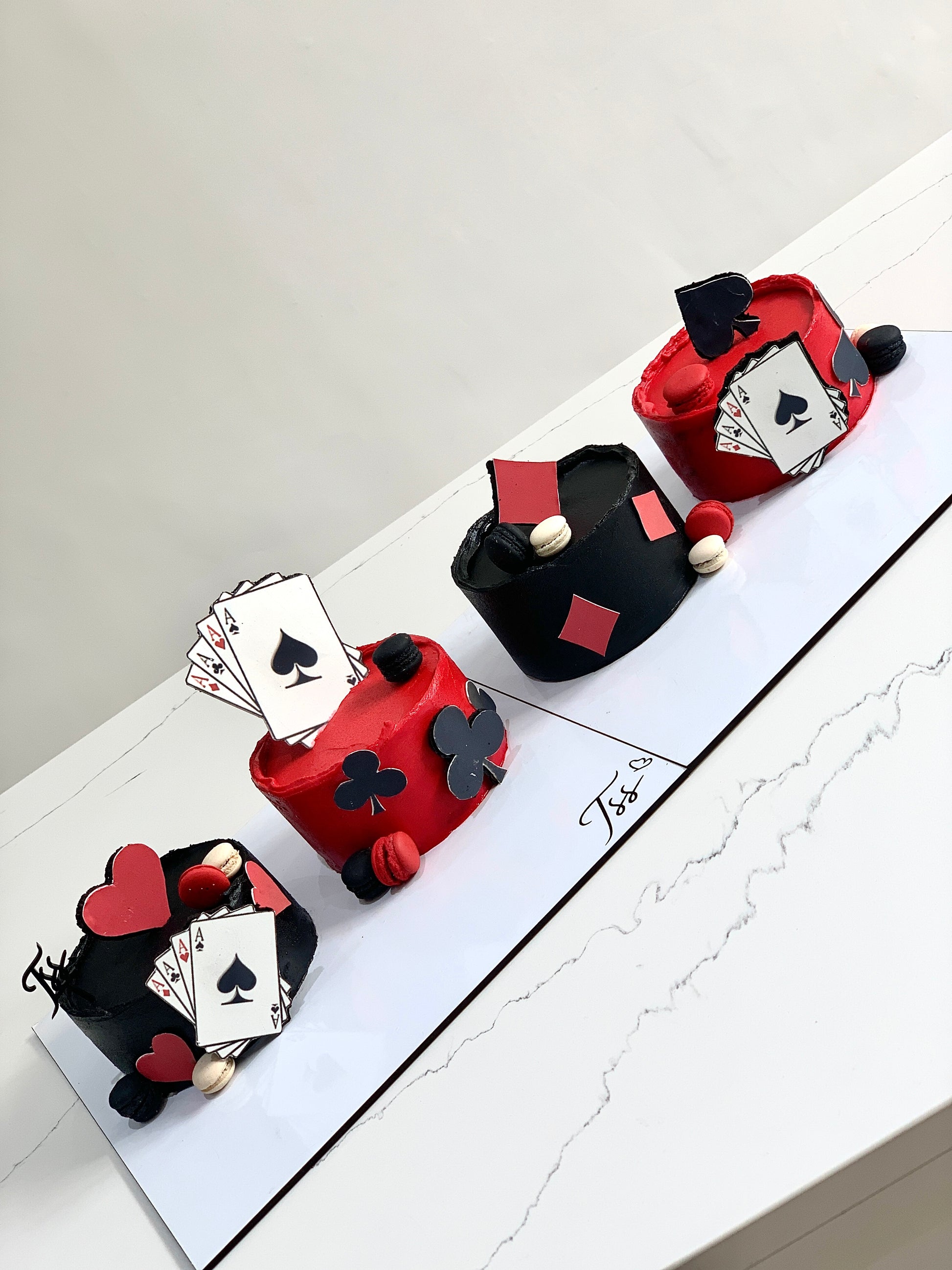 Decorative festive cakes from The Sinful Spoon featuring colorful icing and holiday-themed designs on a white plate.