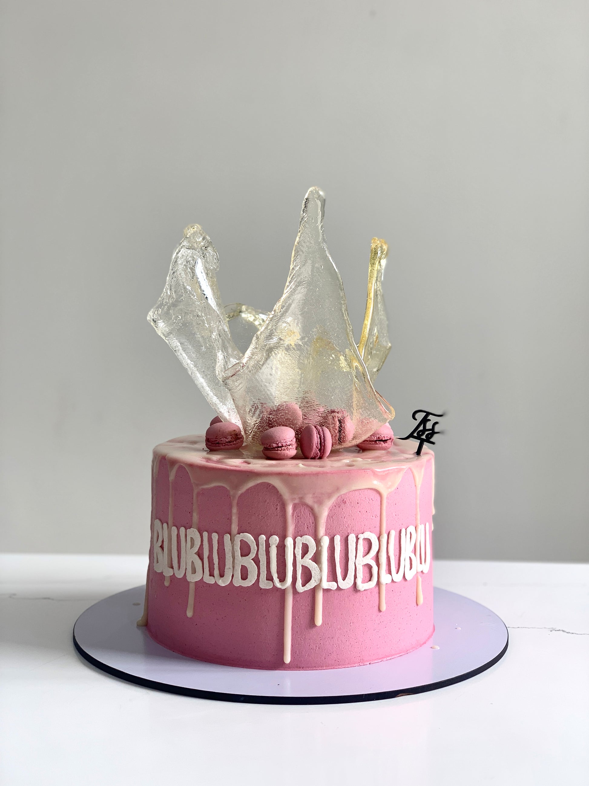 Colorful isomalt cakes from The Sinful Spoon, showcasing vibrant, glossy candy pieces ideal for confectionery decoration.