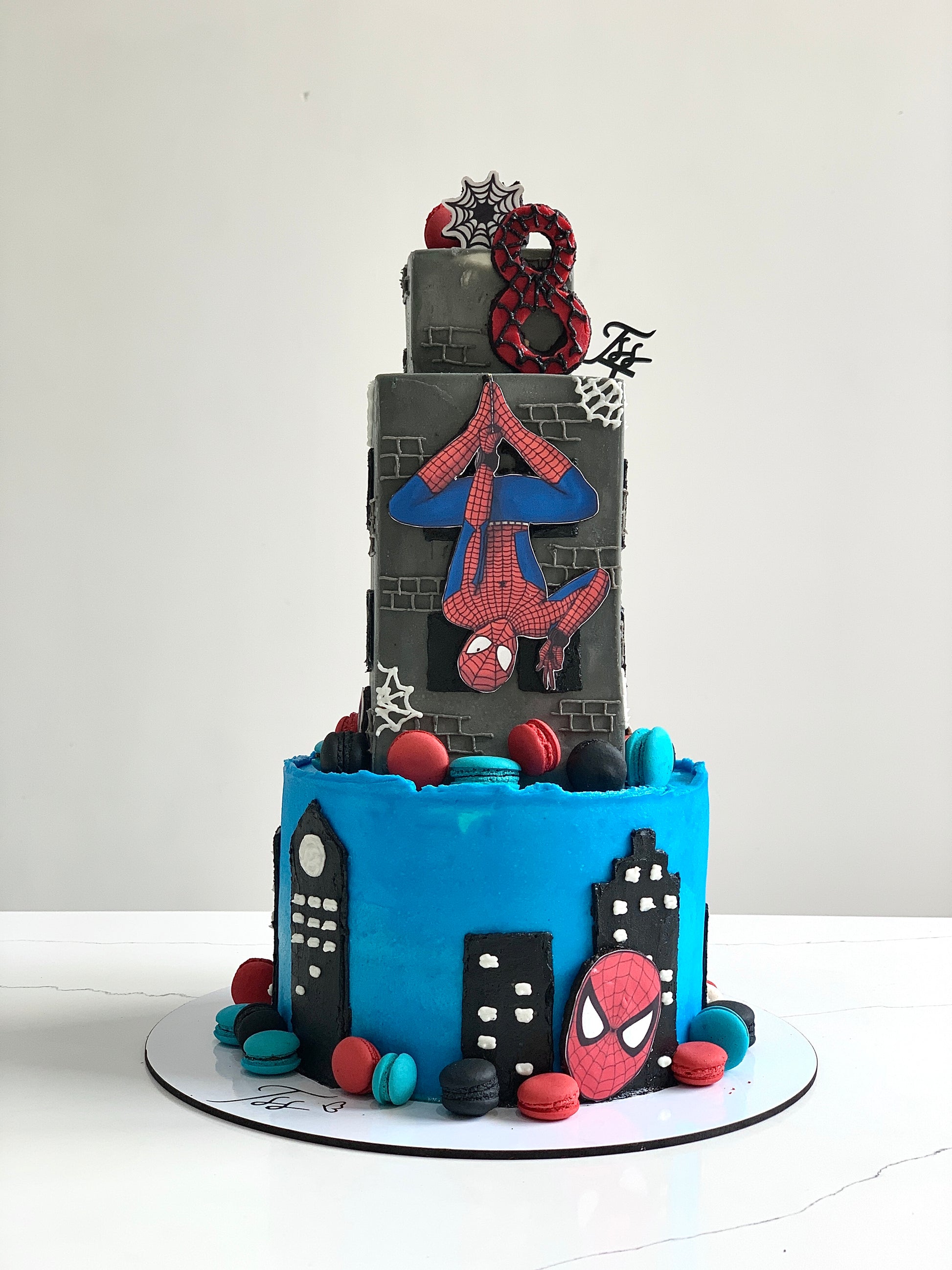 Colorful tiered kids' cake from The Sinful Spoon with vibrant frosting and playful decorations, perfect for celebrations.