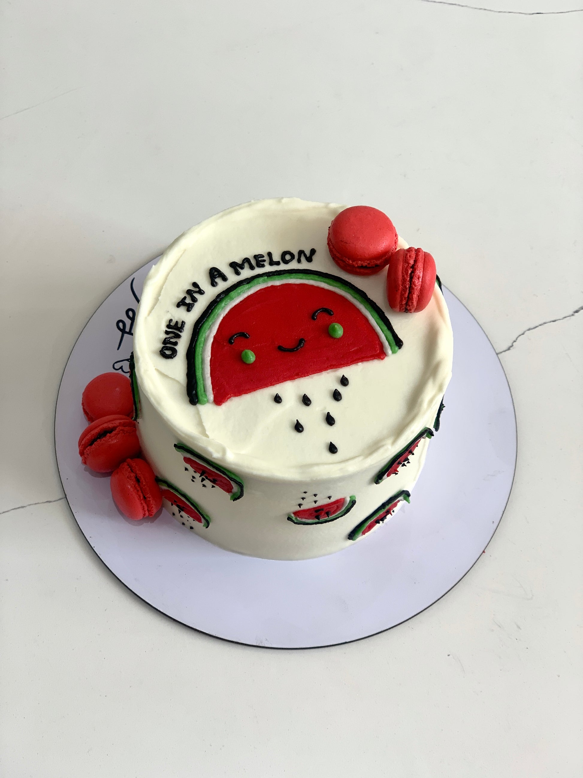 Colorful buttercream illustration cake by The Sinful Spoon with intricate floral and whimsical designs on a round cake.