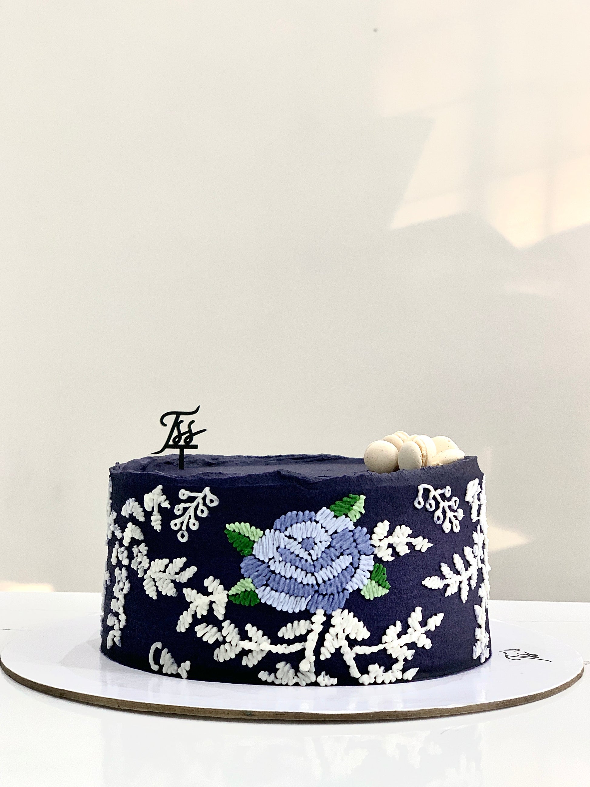 Decorative fashion cake by The Sinful Spoon featuring colorful, intricate icing designs and stylish edible embellishments.