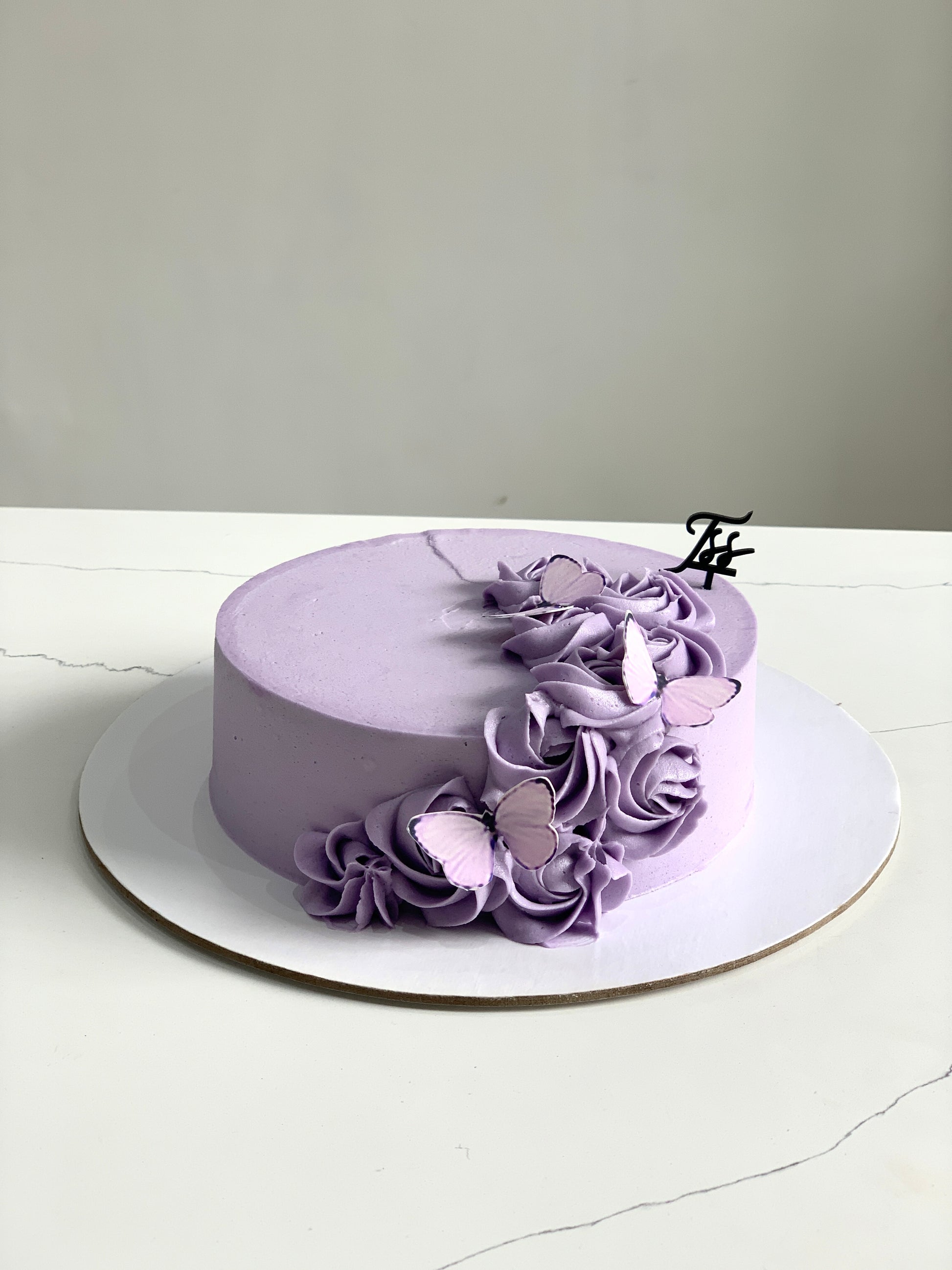 Edible paper cake topper for baby girl themed cake by The Sinful Spoon, featuring delicate pink and white designs.