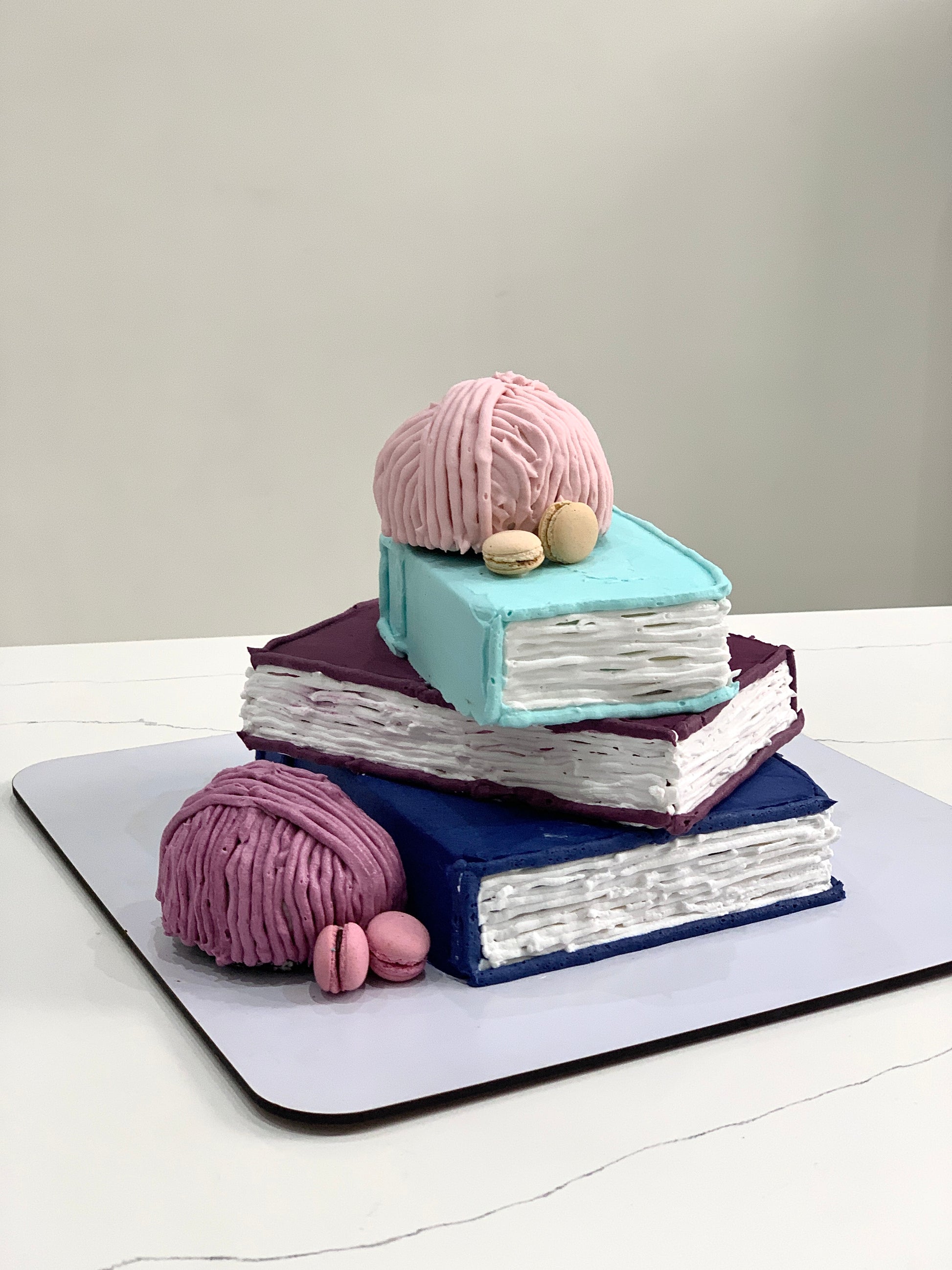 Colorful shape cakes from The Sinful Spoon, arranged in a decorative pattern on a white plate.