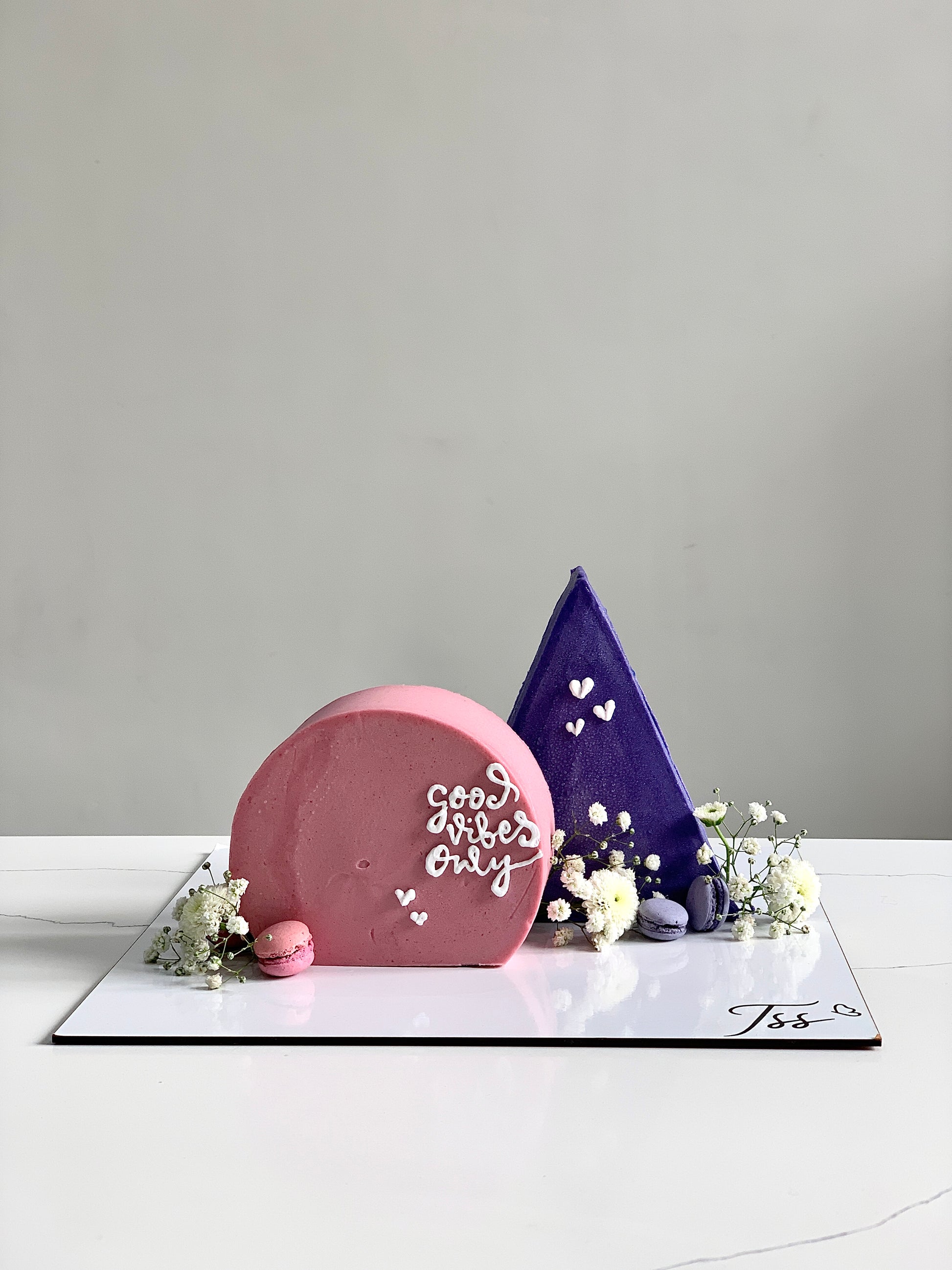 Inverted cakes by The Sinful Spoon featuring colorful layered cake slices on a white plate.