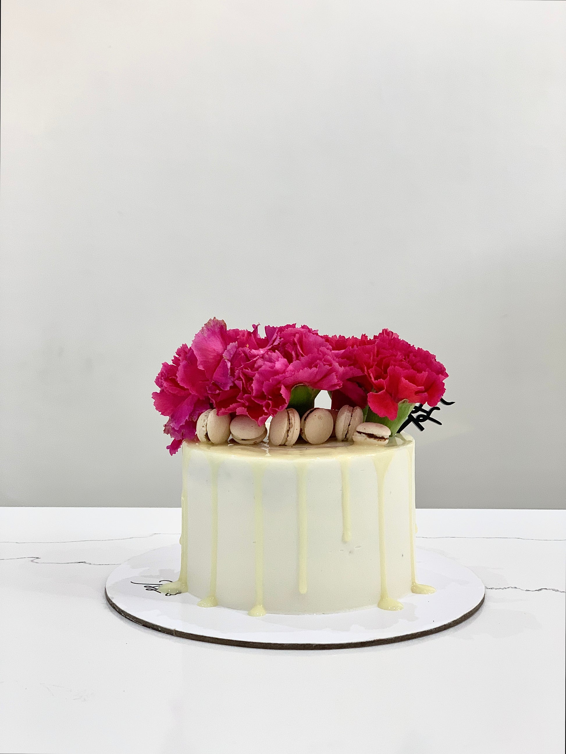 Colorful fresh floral cakes from The Sinful Spoon, decorated with vibrant edible flowers and elegant frosting details.