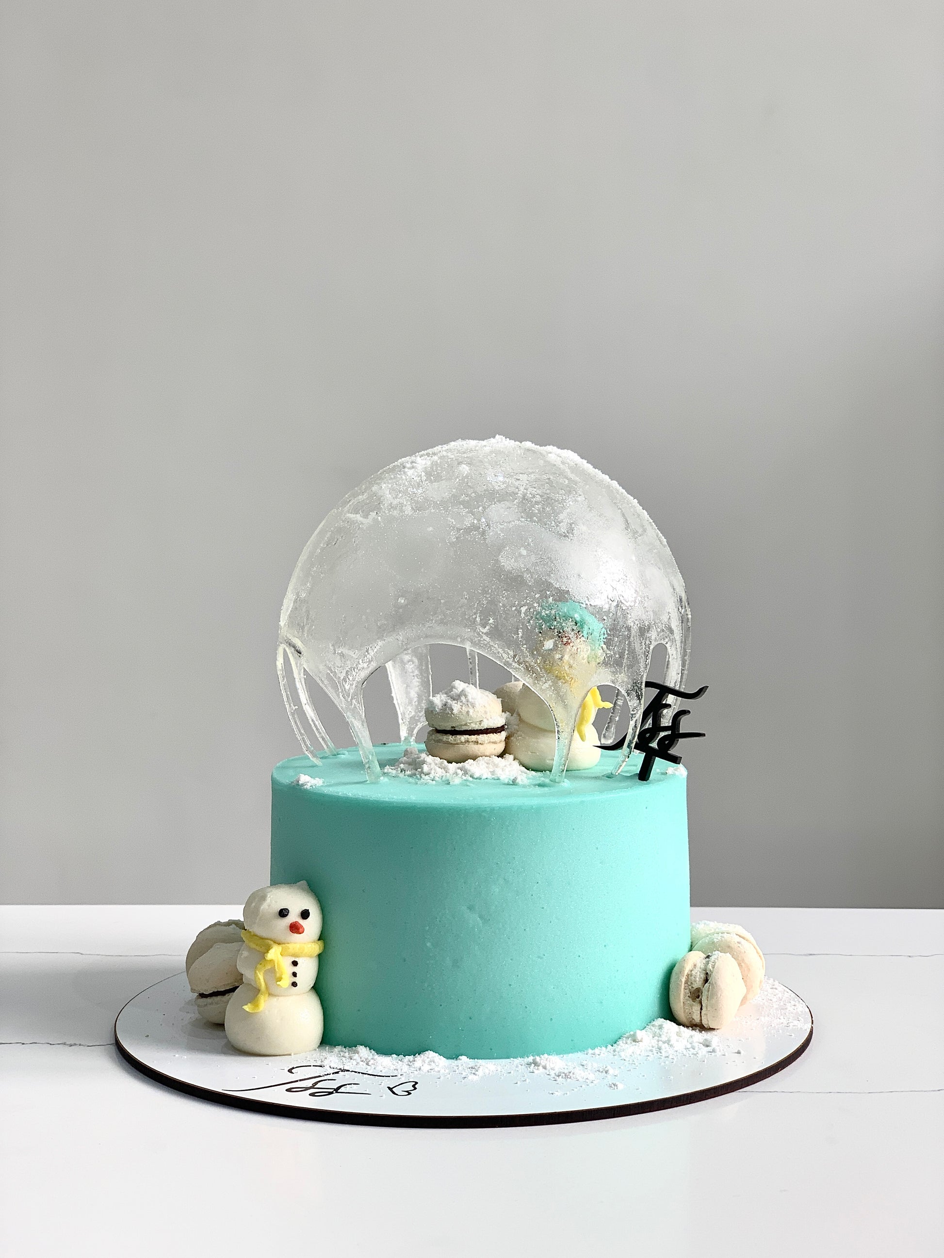 Decorative Christmas cake from The Sinful Spoon with festive icing and holiday-themed toppings, ready for holiday celebrations.
